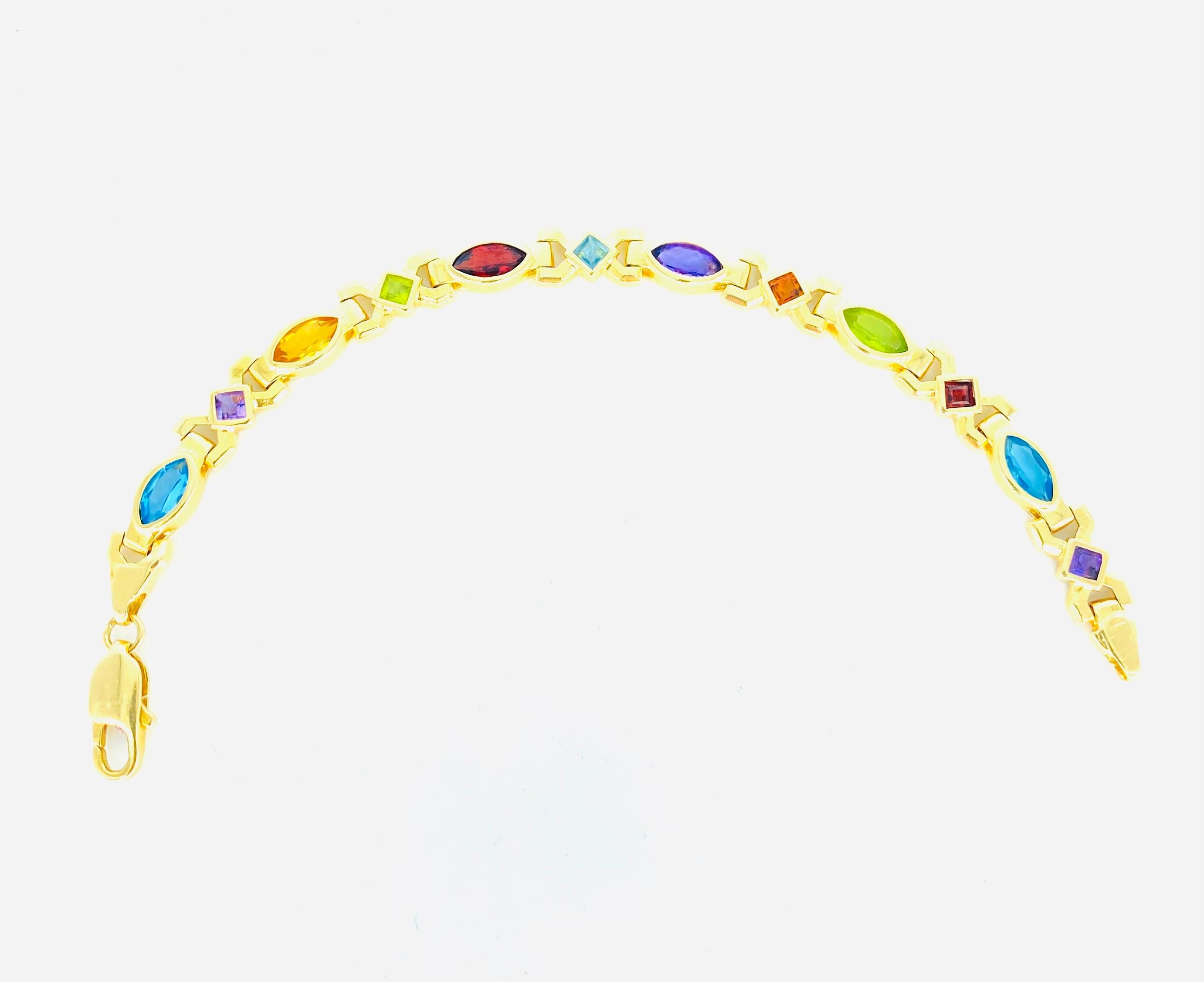 Vintage Multi-Color Mixed Shape Gemstone Bracelet 14k Gold. The bracelet weights a total of 15.3 grams and is 7.6mm in width. The bracelet is 7 inches long.
