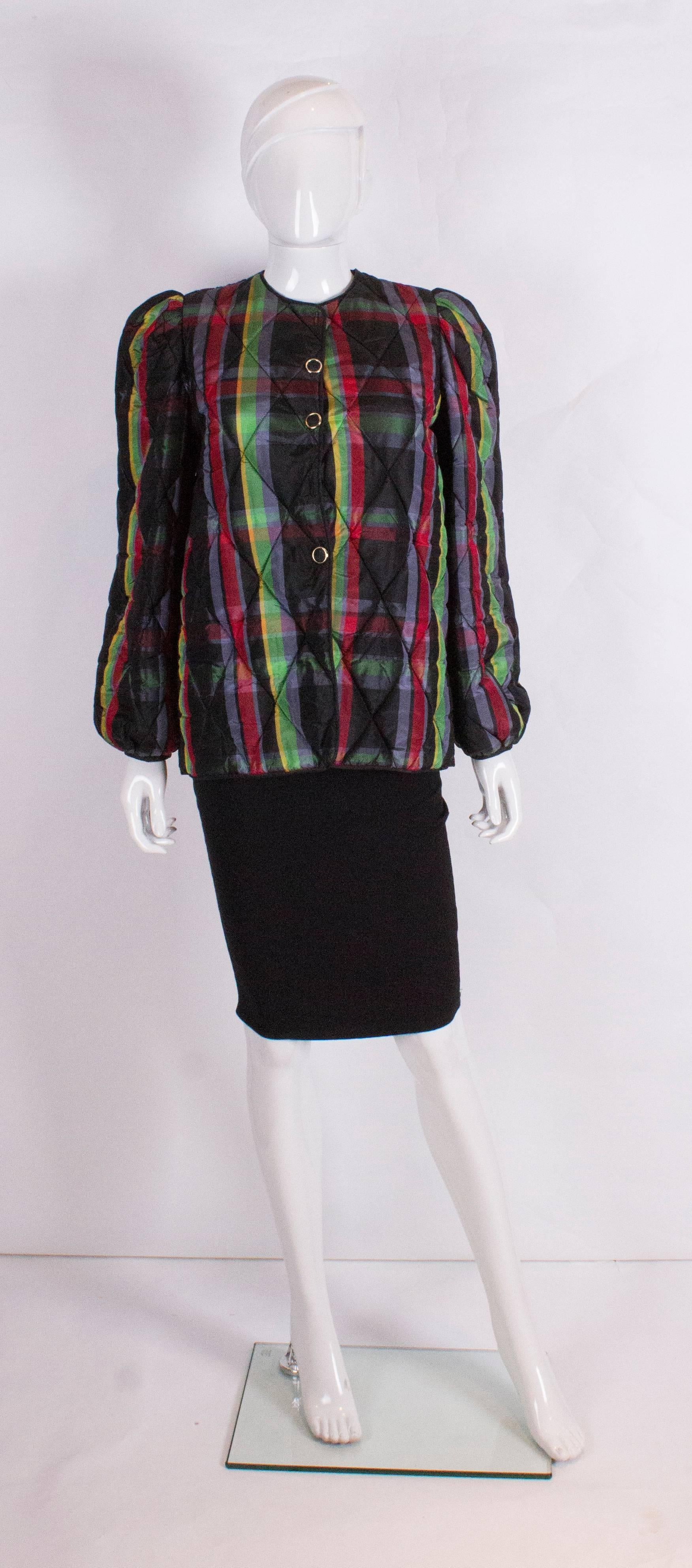 A chic vintage winter warmer, a silk  multi colour quilted jacket. The jacket is collarless, and gathered at the shoulders and cuffs. It is lined in black.