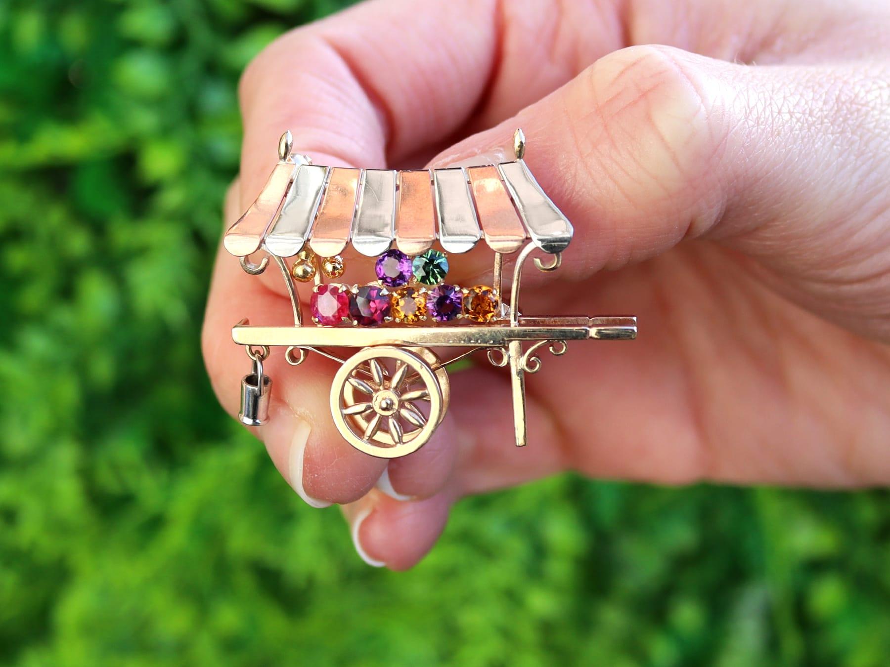 A fine and impressive vintage 0.85 carat citrine, amethyst, tourmaline, ruby and 9 karat gold 'cart' brooch by Alabaster & Wilson; part of our diverse vintage jewelry and estate jewelry collections

This fine and impressive vintage cart brooch has