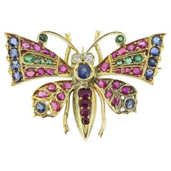 Broche vintage de mariposa con múltiples piedras preciosas