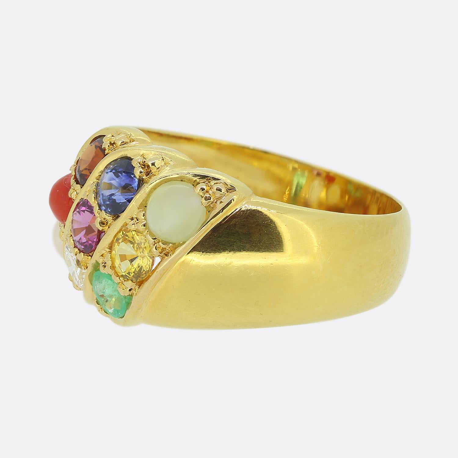 Here we have a delightful multi gemstone cluster ring. This vintage piece has been crafted from 9ct yellow gold and showcases three distinct channels; each consisting of three individually claw set round faceted stones amidst a pair of plain