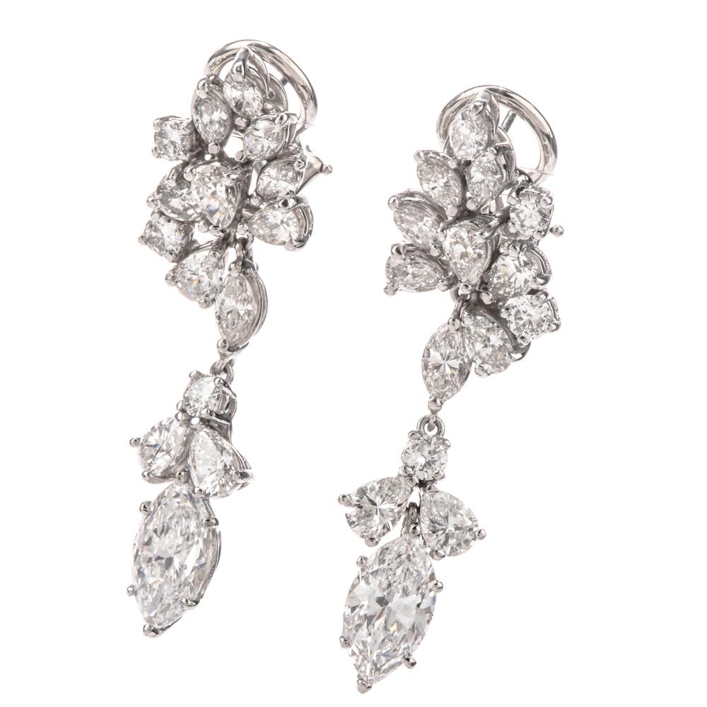 These irresistible platinum dangling earrings are no ordinary floral motif!
As an epitome of grace and elegance, each earring features a
A floral-like cluster of multi-shaped diamonds suspending yet another of Mother Nature’s 
An approximate