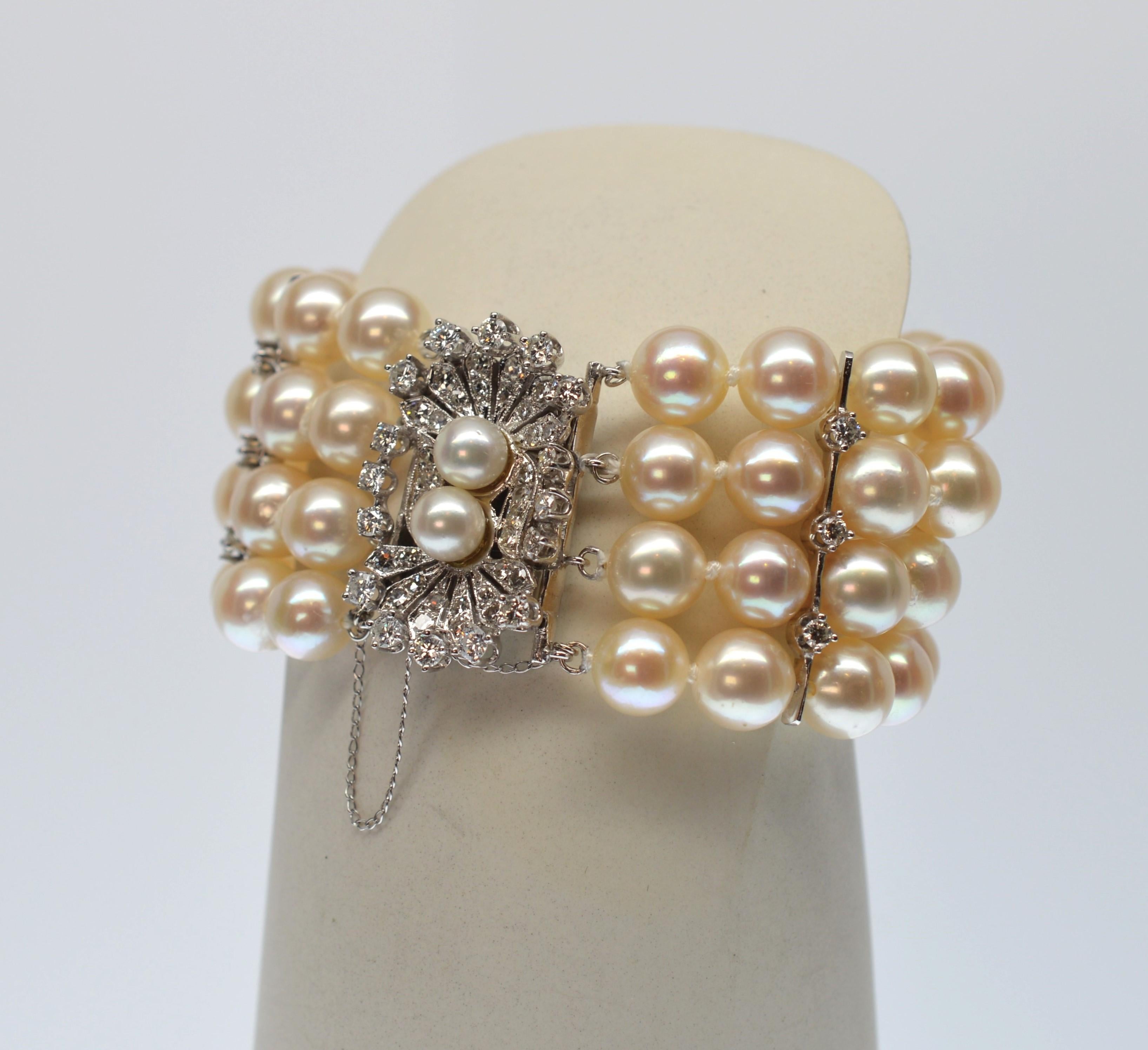 Find vintage glory in this outstanding mid-century jeweled Art-Deco style pearl bracelet. Exquisite, featuring a sparkling diamond covered white gold ornamental clasp which brilliantly hosts four strands of lustrous matching hand-knotted AAA creamy