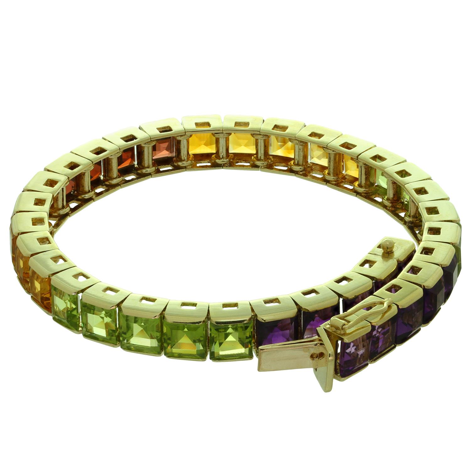 This colorful vibrant rainbow bracelet features 18k yellow gold square links beautifully set with a perfect selection of natural square-cut gemstones - amethyst, citrine, peridot and garnet. Made in United States circa 1980s.  Measurements: 0.23