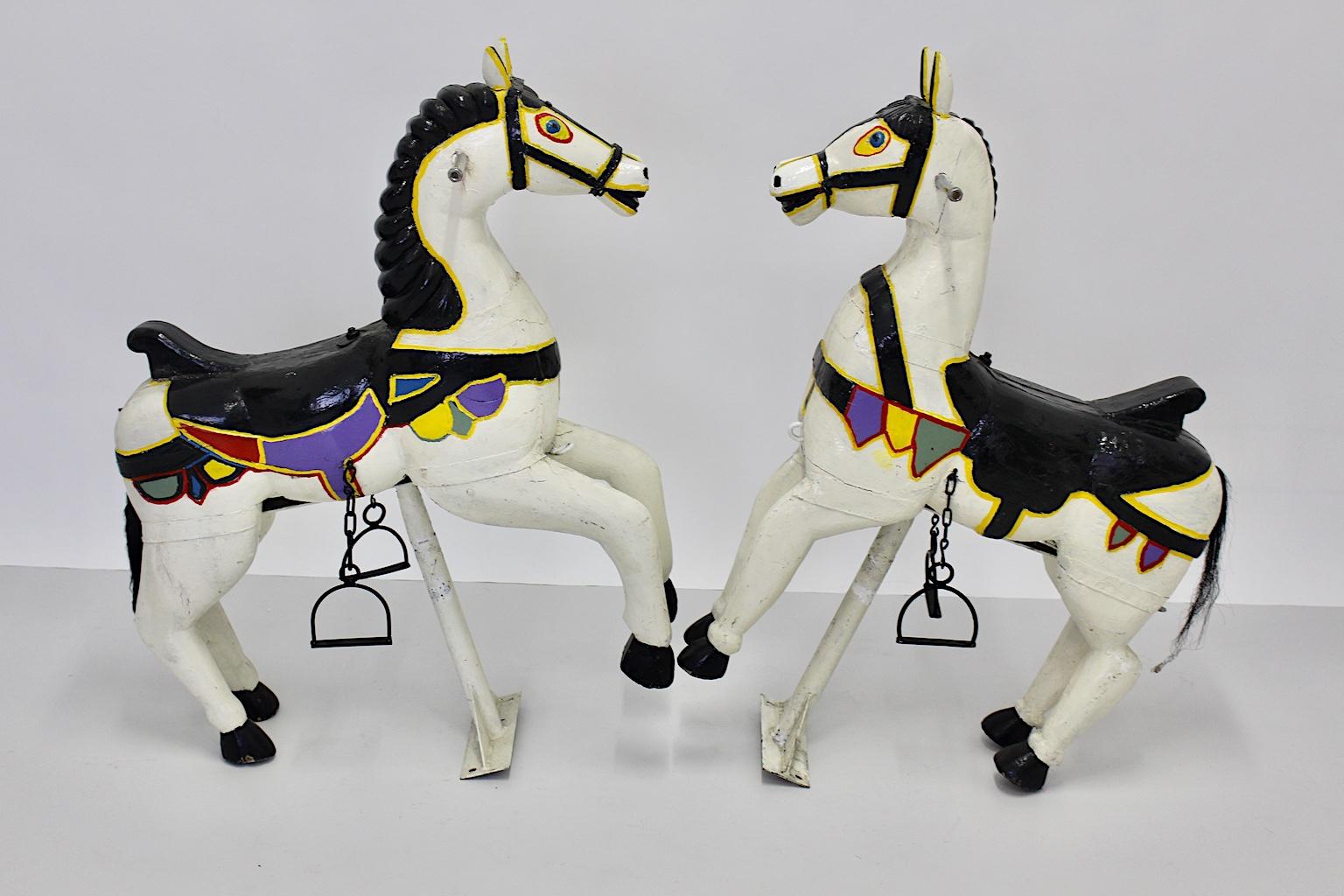 Antique vintage pair of carousel horses from multicolored lacquered wood Austria circa 1890.
The carousel horses feature a carved wooden white lacquered body with white lacquered iron and sheet metal details.
The horses are very similar but show