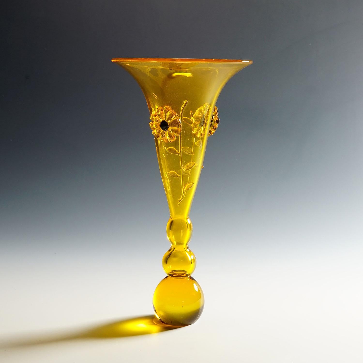 Vintage Murano Art Glass Vase by Franco Moretti circa. 1970s

A vintage Murano art glass vase designed by Franco Moretti circa 1970s. Honey yellow glass with applications in the form of flowers. Incised signature 'Moretti Franco' on the