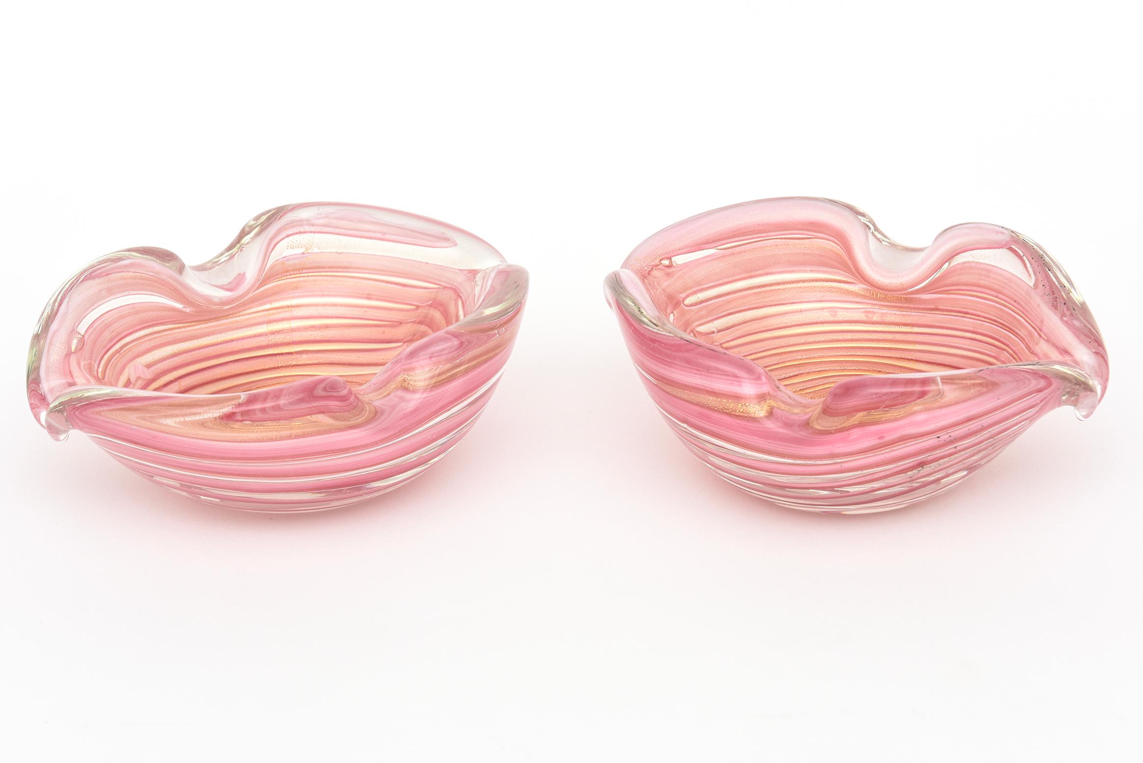 This vintage pair of rare gorgeous Murano glass bowls were designed by Ercole Barovier for the Barovier e Toso Glass Co. There are rows and layers of pink stripes graduated in sizes and thickness with abundant heavy gold packed flecks and gold leaf
