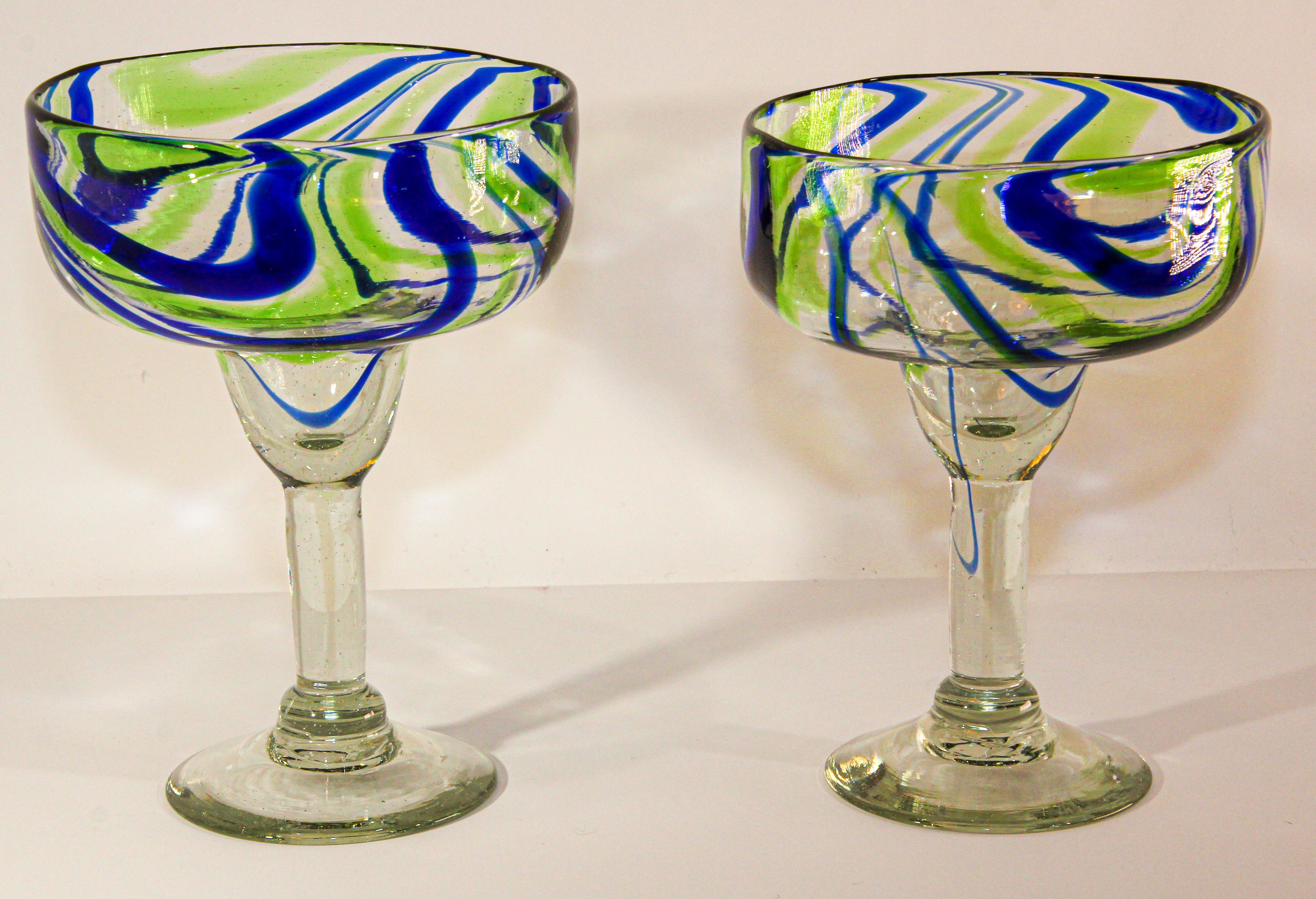 Vintage Post Modern Murano Martini Glasses Set of 2 Colorful Barware.
The glasses are hand blown with colorful abstract design in blue and green waves, each one is unique in design and size.
Measures: 5