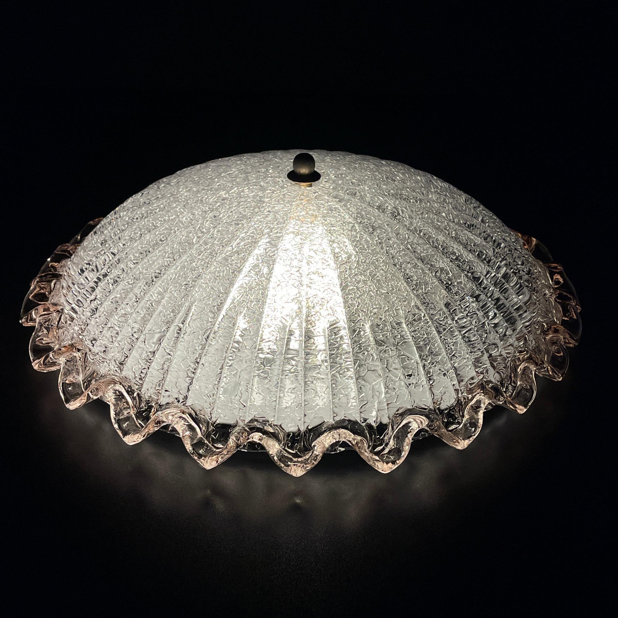 Step into the allure of mid-century Italian design with this vintage Murano ceiling lamp, a true testament to the timeless elegance of 1980s craftsmanship. Handcrafted in Italy, this exquisite piece embodies the essence of Italian modern lighting,