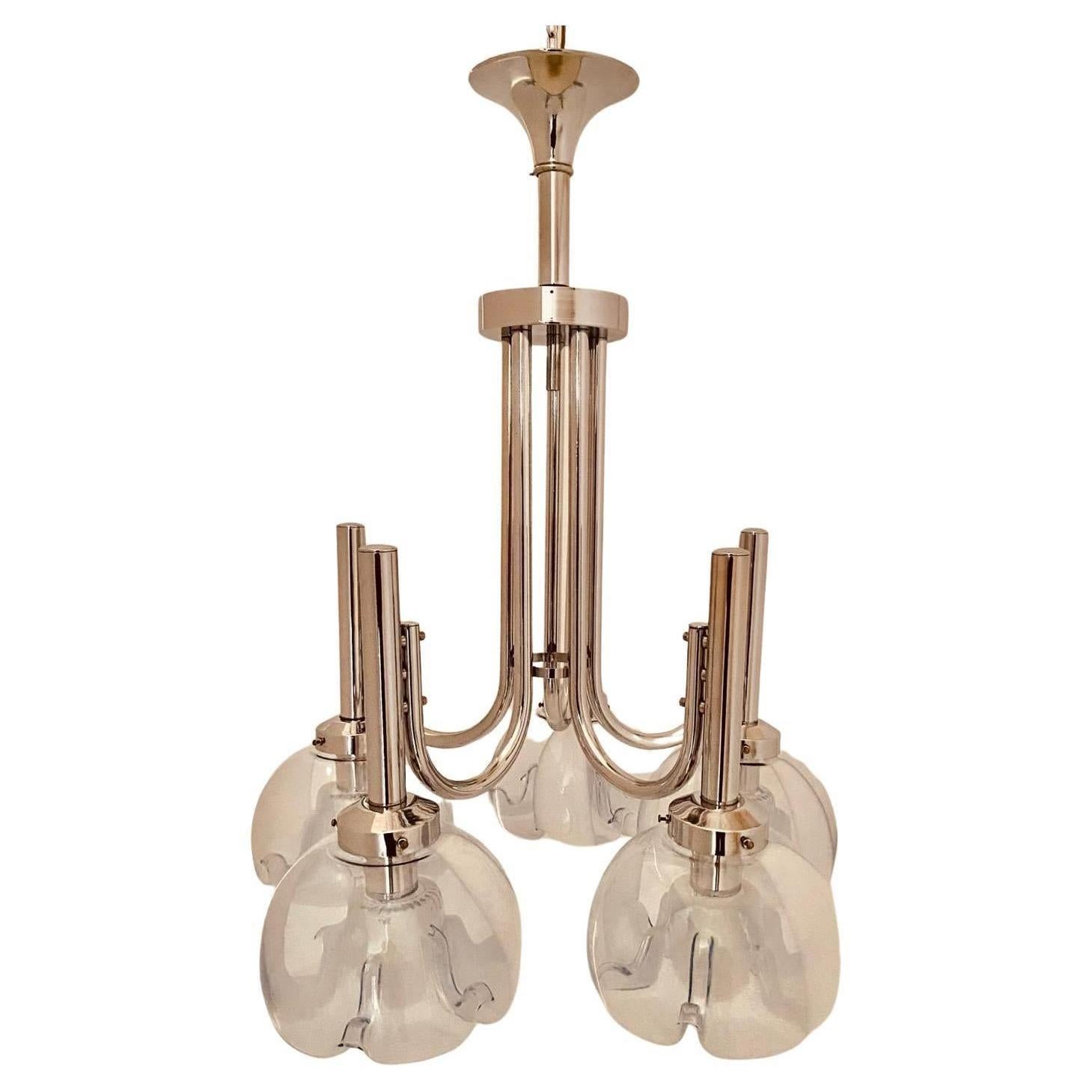 Vintage chromed chandelier from the late 1960s designed and manufactured by Mazzzega, Italy. Distinctive shape reminiscent of the classic Venetian chandelier in a stylized form.

The chandelier consists of a chrome-plated steel frame with five light