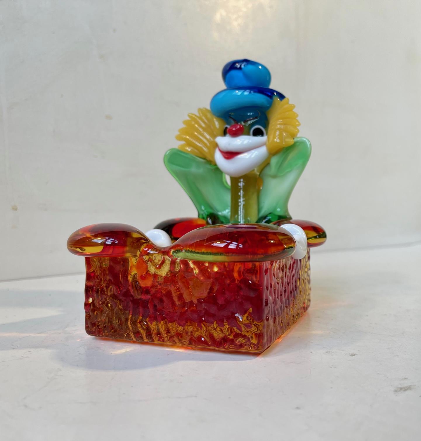 Colorful Murano ashtray in shape of a clown. Hand-made in Murano Italy during the 1970s, probably by Vetri. Measurements: H: 15 cm, W: 11 cm, Dept: 11 cm.