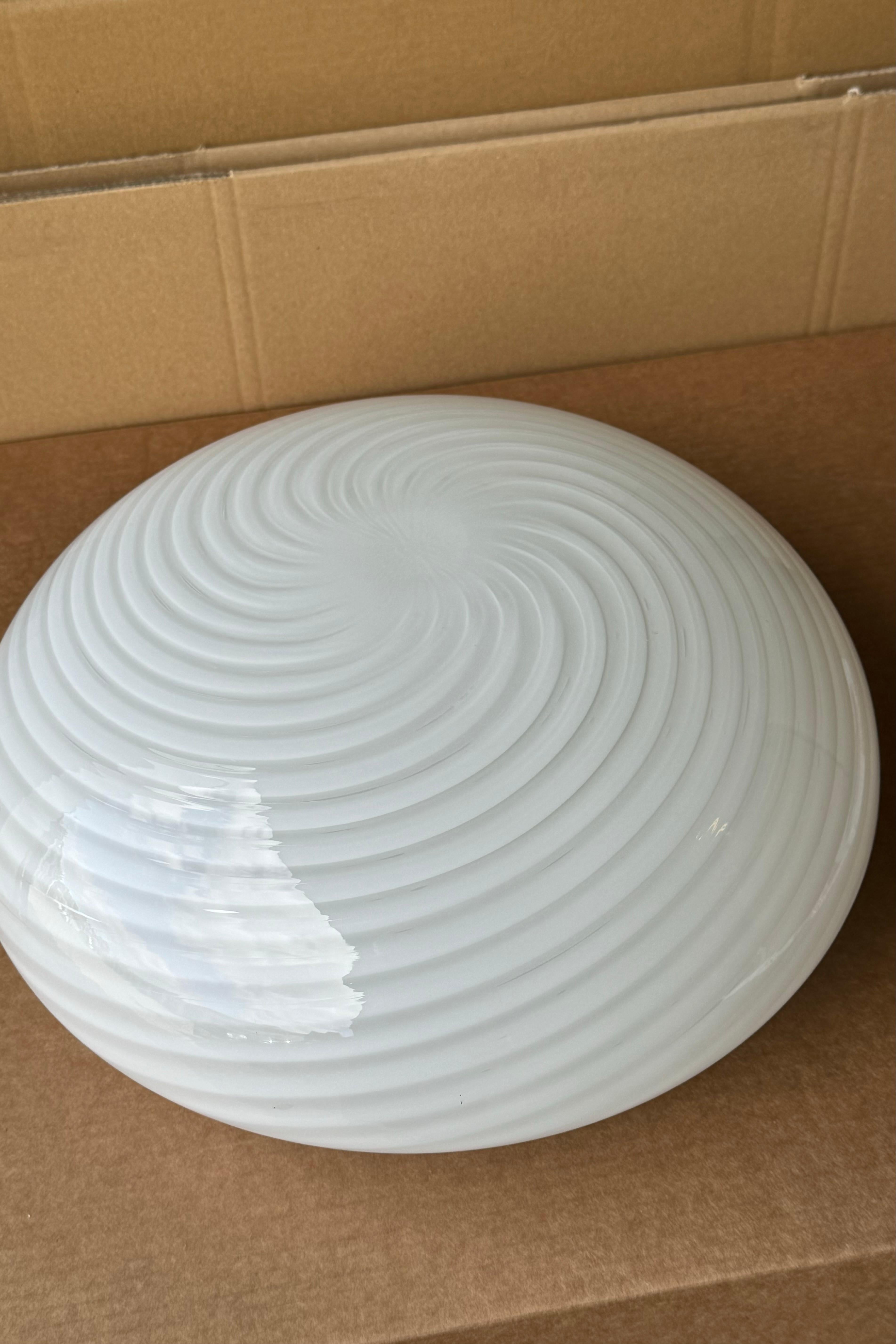 Vintage Murano Plafond Deckenleuchte / Wandleuchte. Mundgeblasenes weißes Opalglas mit Wirbel und weißem Boden. E27-Fassung. Handgefertigt in Italien, 1970er Jahre.
T:36 cm H:16 cm
