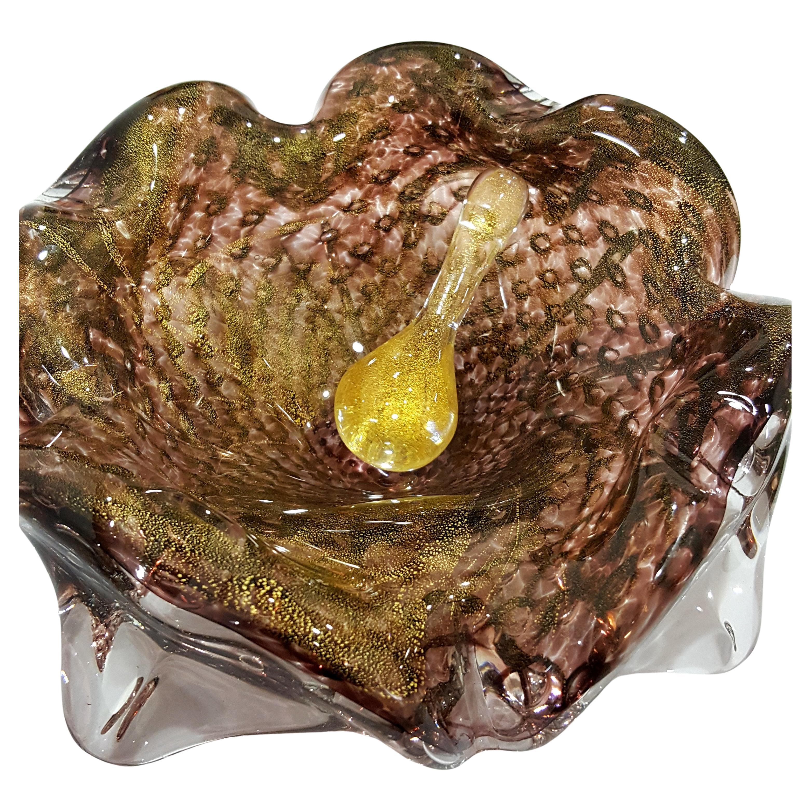 Vintage Murano Glass Ashtray w/Snuffer by Galliano Ferro - has original label.
This is a two piece item -- bullicante and gold polveri infused glass ashtray with gold polveri infused snuffer. This is the item for those who seek something unusual.