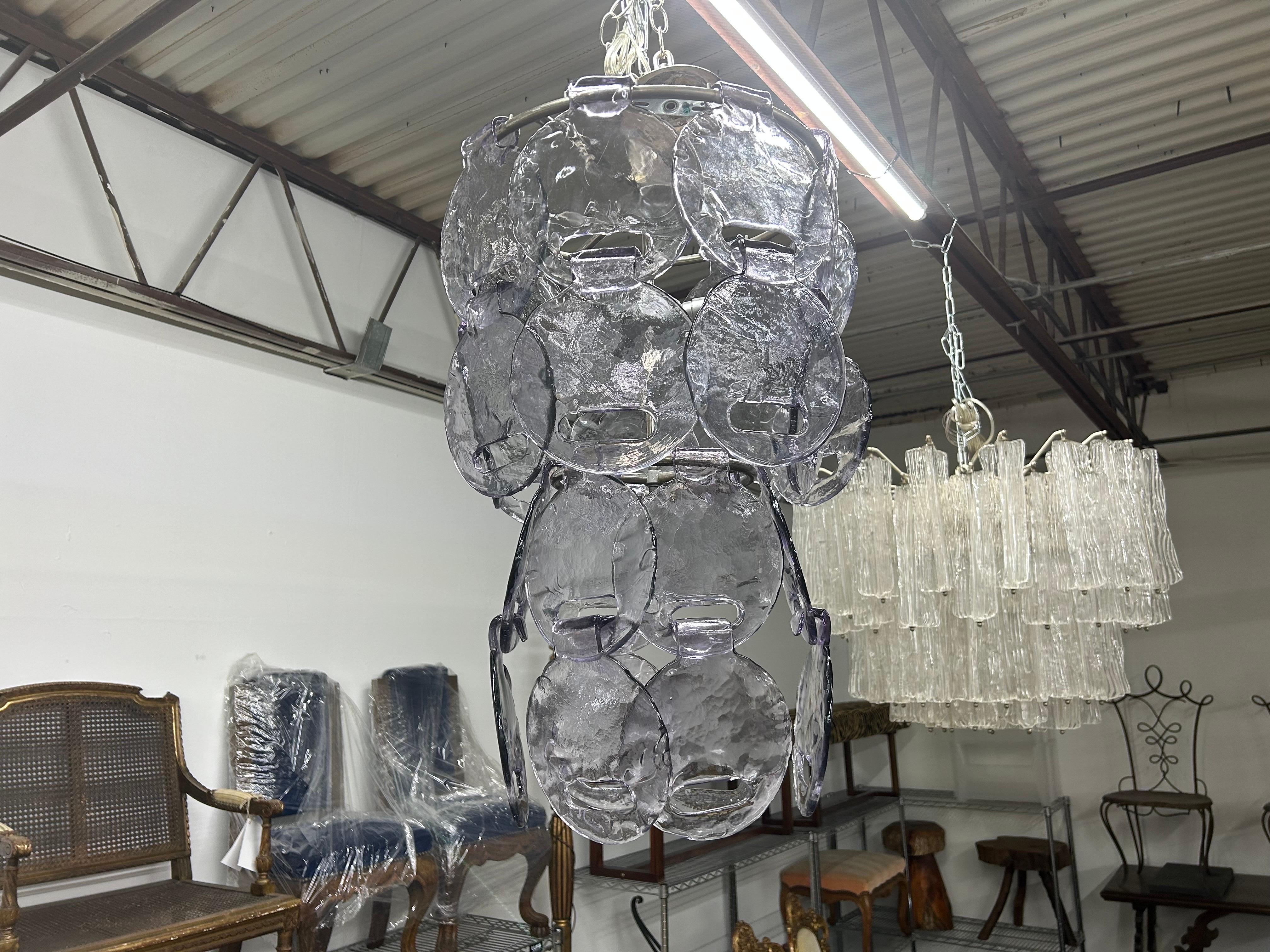 Vintage Murano Glass Chandelier By Carlo Nason For Mazzega.
Italian mid century modern interlocking lavender Murano glass chandelier on chrome base by Carlo Nason for Mazzega.
This stunning chandelier is comprised of beautiful hand blown lavender