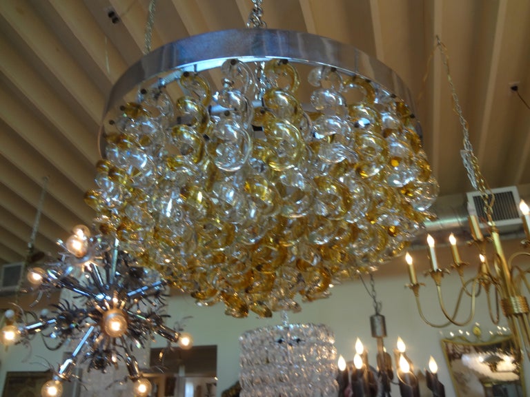 Unusual Hollywood Regency Italian Murano chandelier by Mazzega, Italy. This stunning Mid-Century Modern murano glass chandelier is comprised of clear and gold colored corkscrew shaped hand blown Murano glass. This vintage Italian chandelier has been