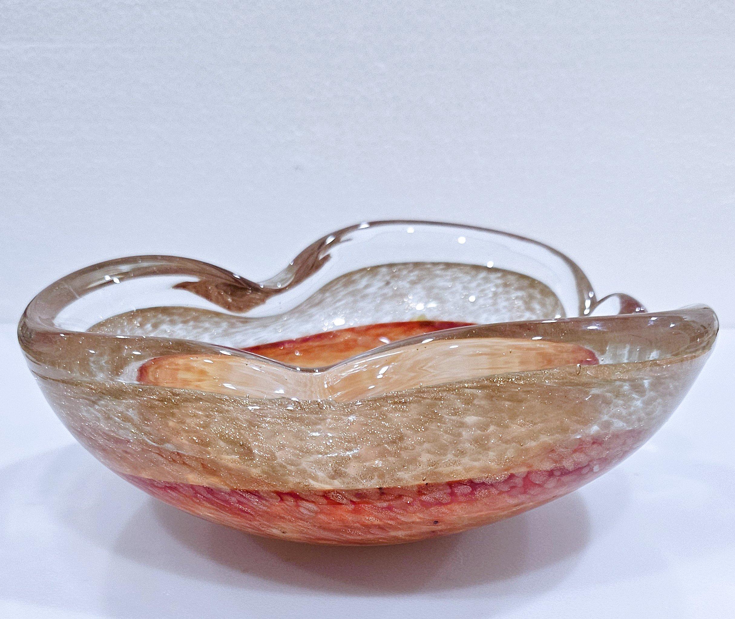 Vintage Murano Glass Dish / Bowl with Gold Fleck
A lovely work of Murano glass artistry in good vintage condition.
7.5 x 7 x 3 inches (apx)
Please note that the colors seem to look notably brighter/more saturated in the photos here than in person,
