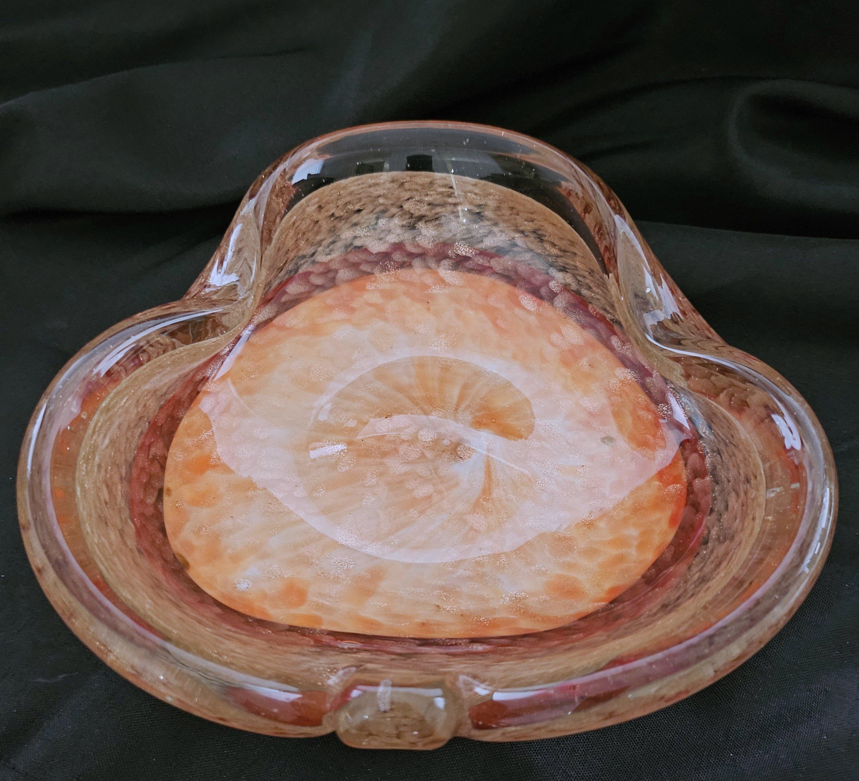 Vintage Murano Glass Dish / Bowl with Gold Fleck or Aventurine
A lovely work of Murano glass artistry in good vintage condition.
7.5 x 7 x 3 inches (apx)
Please note that the colors seem to look notably brighter/more saturated in the photos here