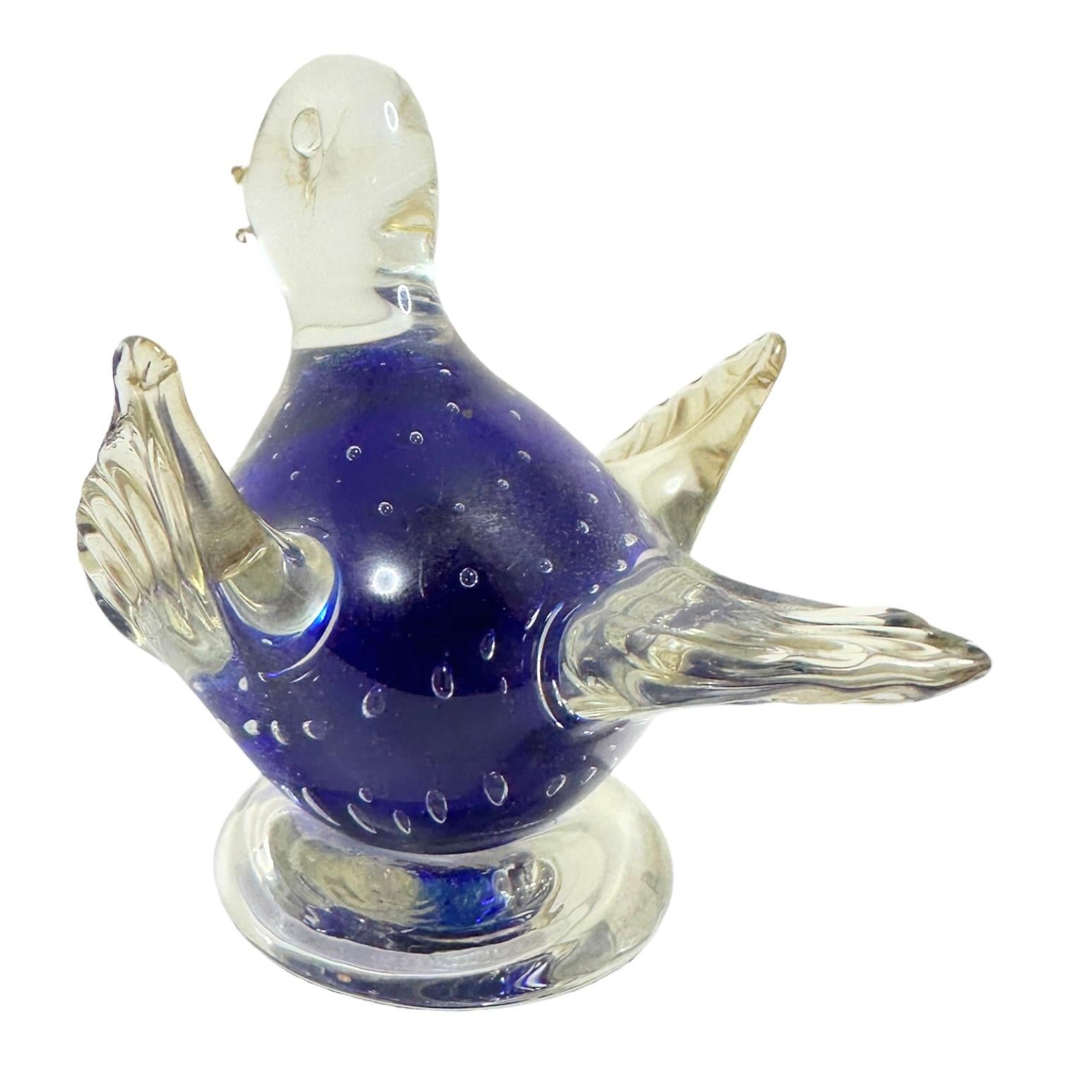 This vintage murano glass paperweight features a delightful sitting bird design. The clear and blue glass gives the paperweight a charming cuddly appearance. This Italian original is a perfect addition to any collection of decorative glassware, and