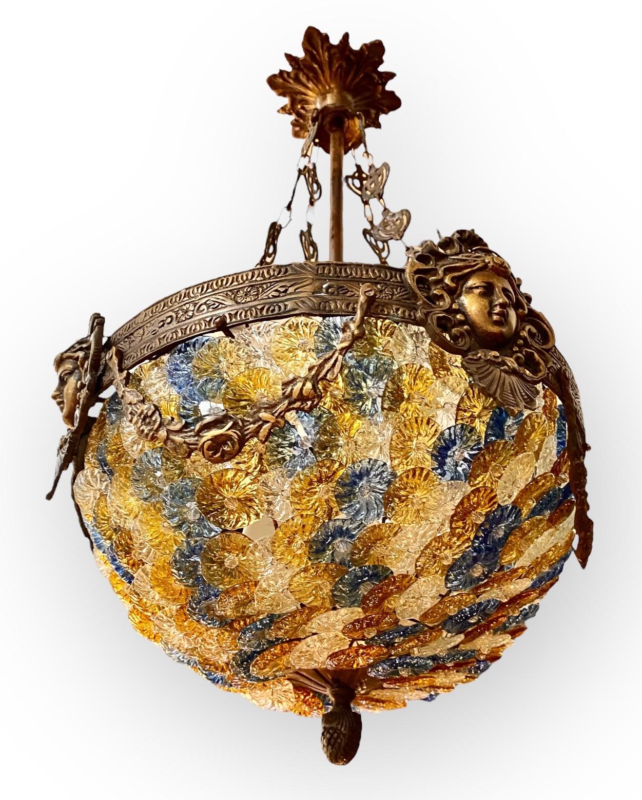 A 1930’s vintage Italian bronze and Murano glass Empire style pendant chandelier having dozens of colorful, beaded glass flowers in shades of blue, yellow, gold and amber. All are individually attached to the frame with wire. The glass has a