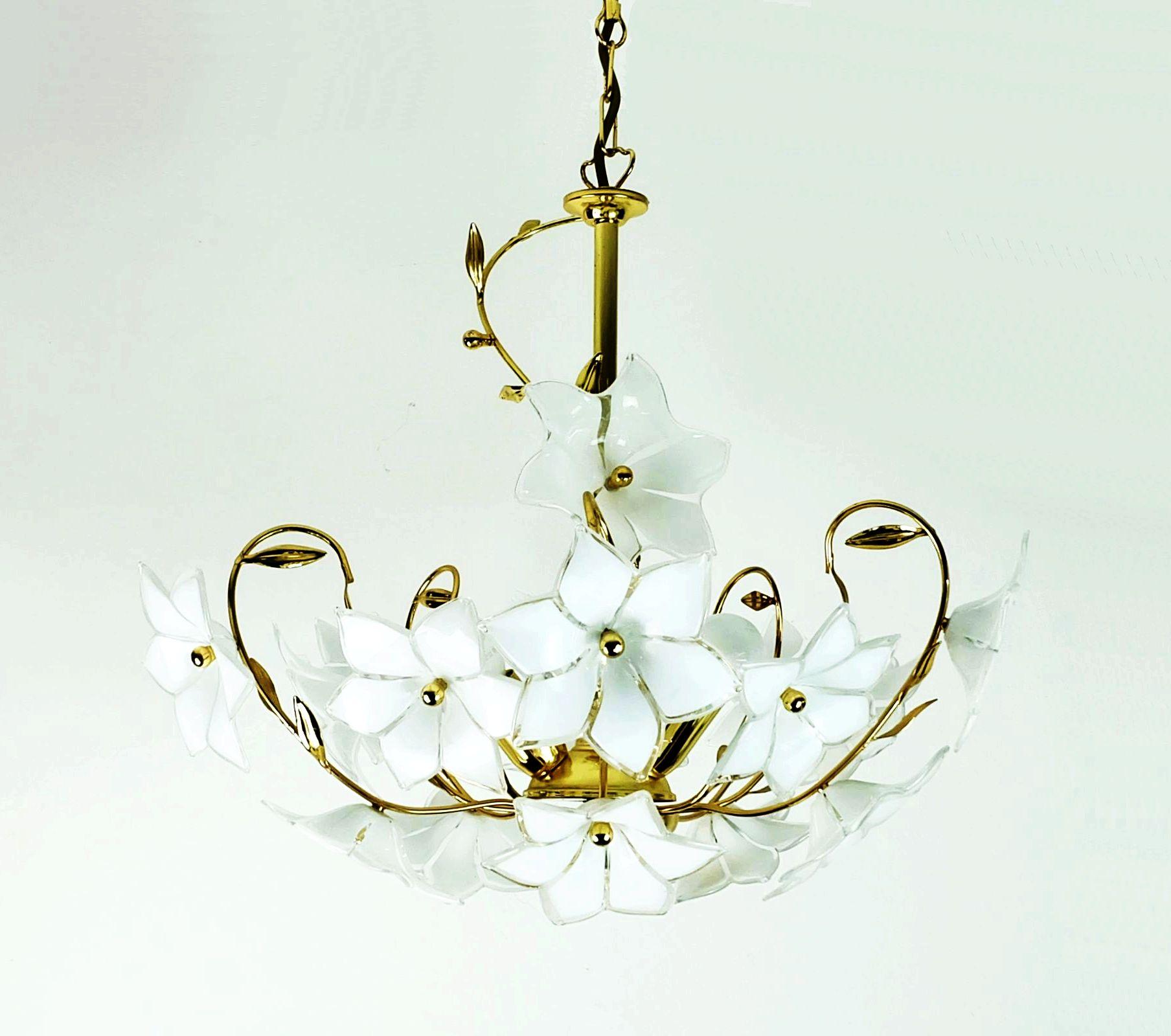 Beautiful mid-century pendant lamp from the 1970s to 80s. The frame is made of gold-colored metal. The arms are designed in the form of leaf tendrils with beautifully crafted leaves. A total of 16 flowers made of white Murano glass with a