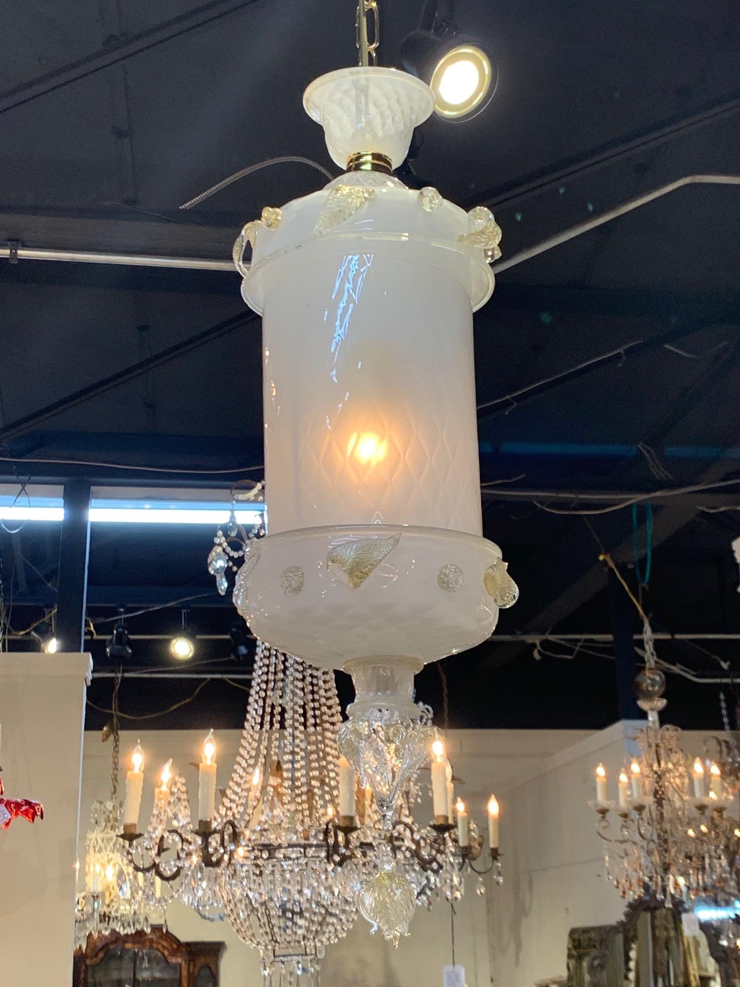 Stunning pair of vintage Murano glass lanterns. Milky white Murano glass with touches of gold. Great scale and shape on these. Adds a beautiful decorative touch!! Note: Price listed is per item.