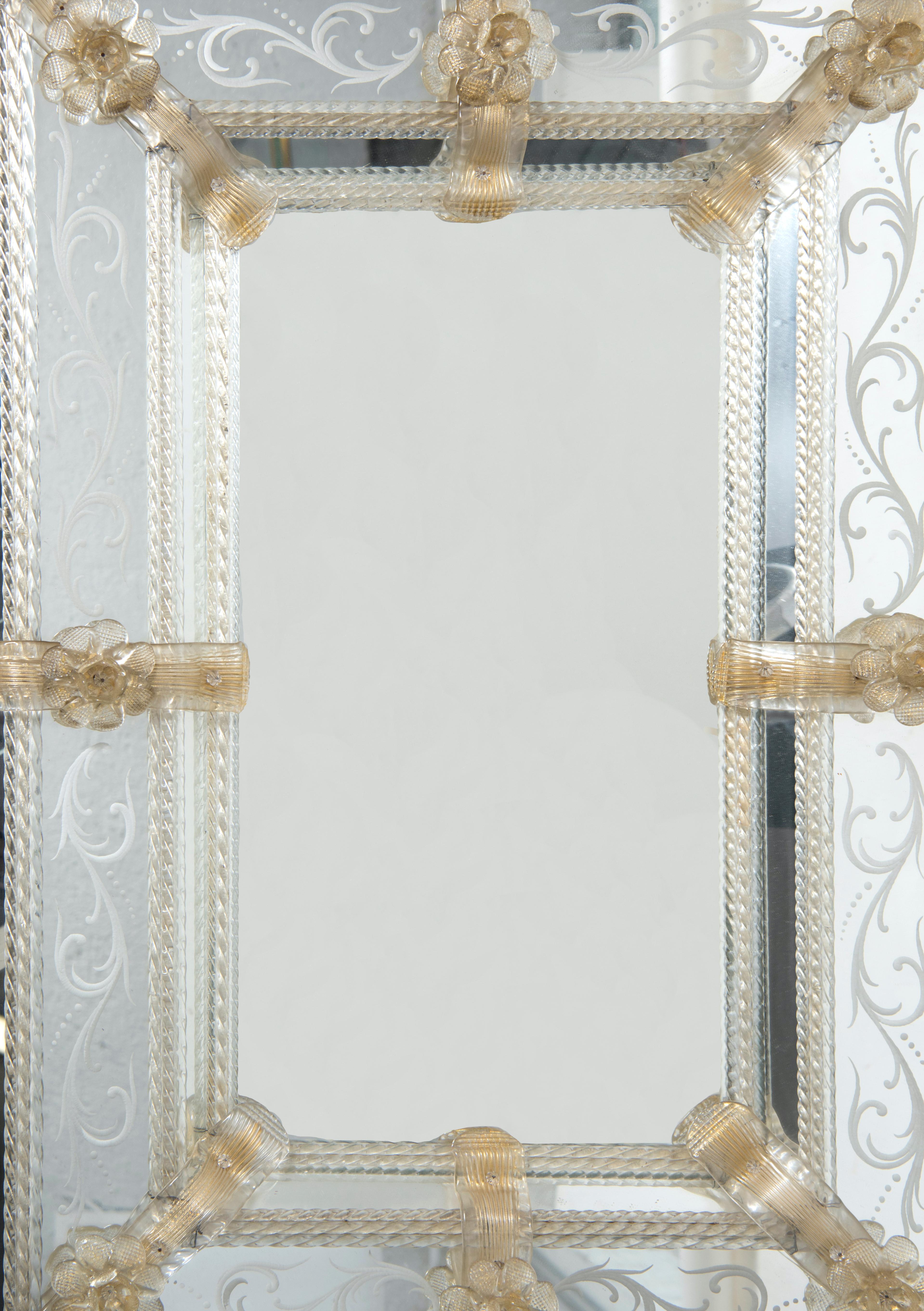 Murano glass mirror is an original Murano glass mirror realized in Murano (Italy) during the first quarter of the 20th century.

This elegant rectangular Murano glass mirror has engraved floral decorations and glass applications with golden