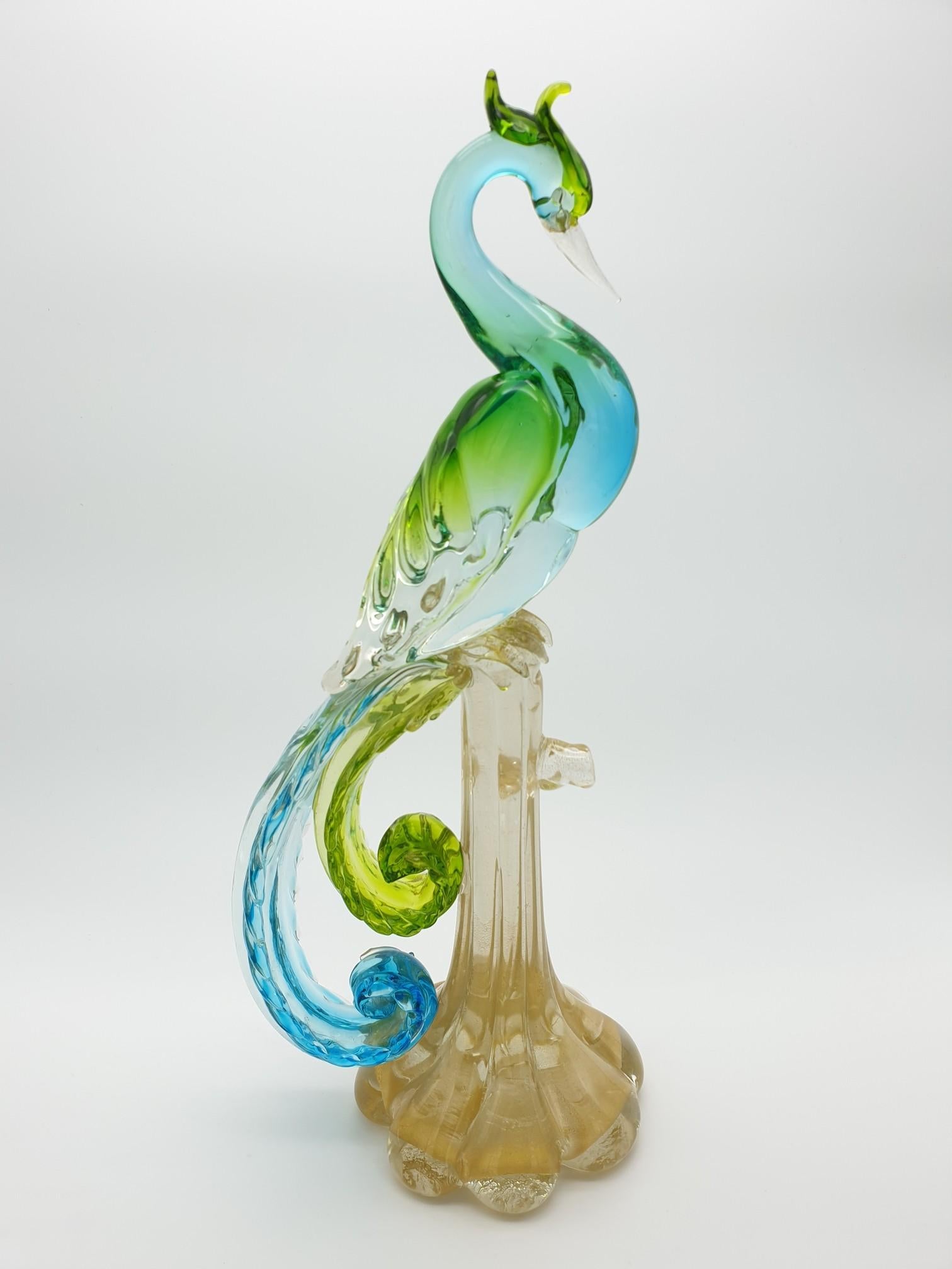 This vintage Bird of Paradise is high 43 cm, it was made by the glass factory 