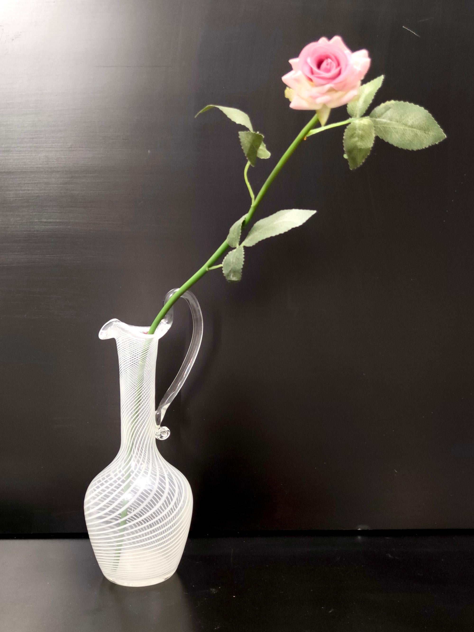 Made in Italy, 1950s. 
This pitcher vase is made in Murano glass and features transparent and white canes. 
It is a vintage item, therefore it might show slight traces of use, but it can be considered as in excellent original condition and ready to