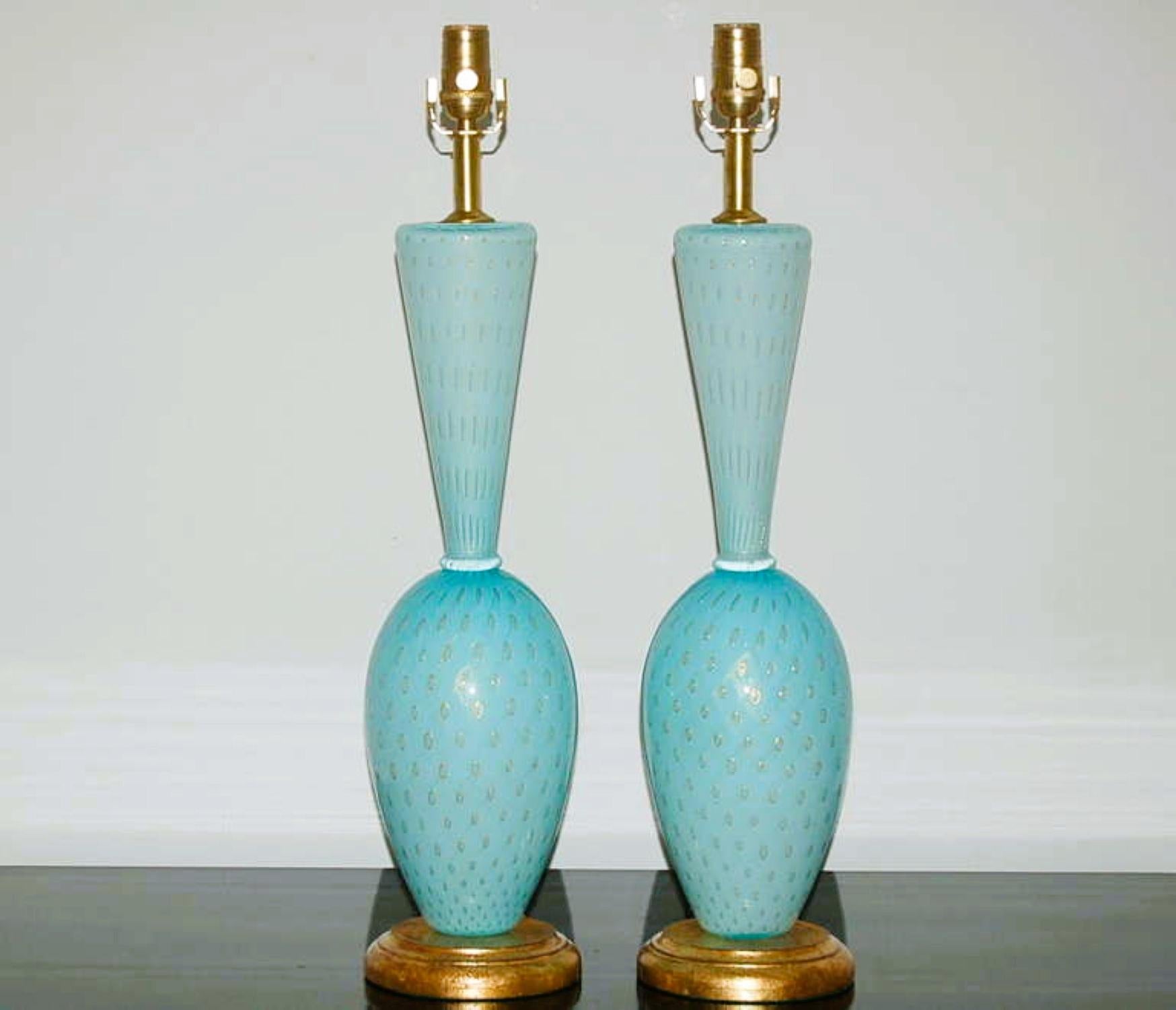 Vintage Venetian glass table lamps in ROBIN EGG BLUE.  Softly curved transitional style with GOLD rimmed controlled bubbles.  Incredible pattern and detail.

The lamps stand 25 inches from tabletop to socket top. As shown, the top of shade is 31