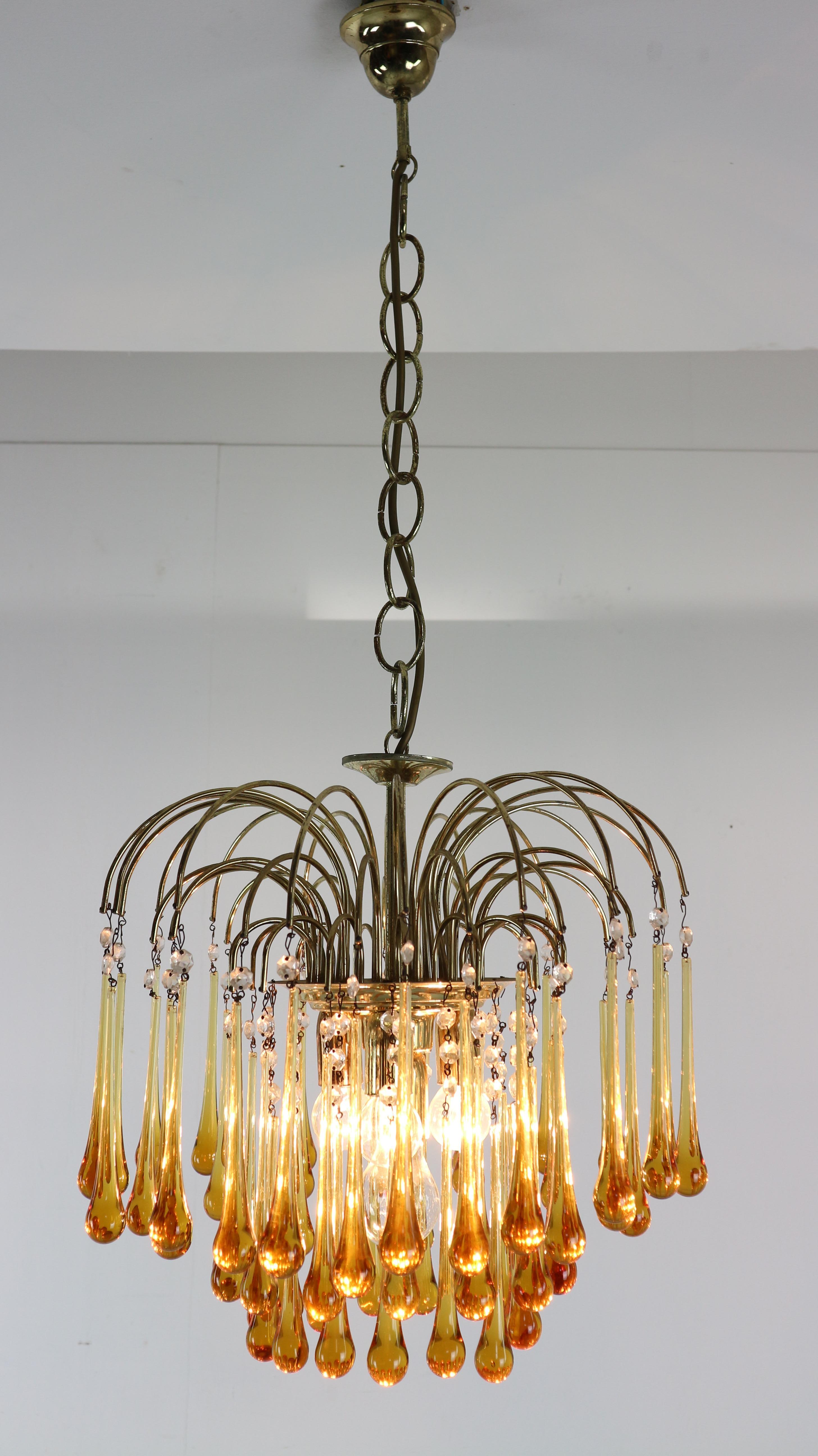 Vintage Murano glass chandelier designed by Paolo Venini in the 1960s, Italy. The glass cascades to reveal a fountain of light. Brass frame.