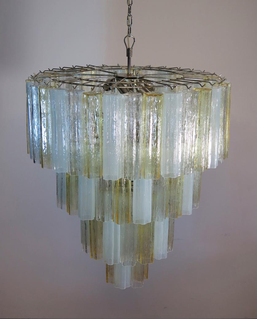 Italian vintage chandelier in Murano glass and nickel-plated metal structure on 4 levels. The armor polished nickel supports 78 large amber glass tubes in a star shape. The glasses have three beautiful colors, amber, transparent and opal silk;