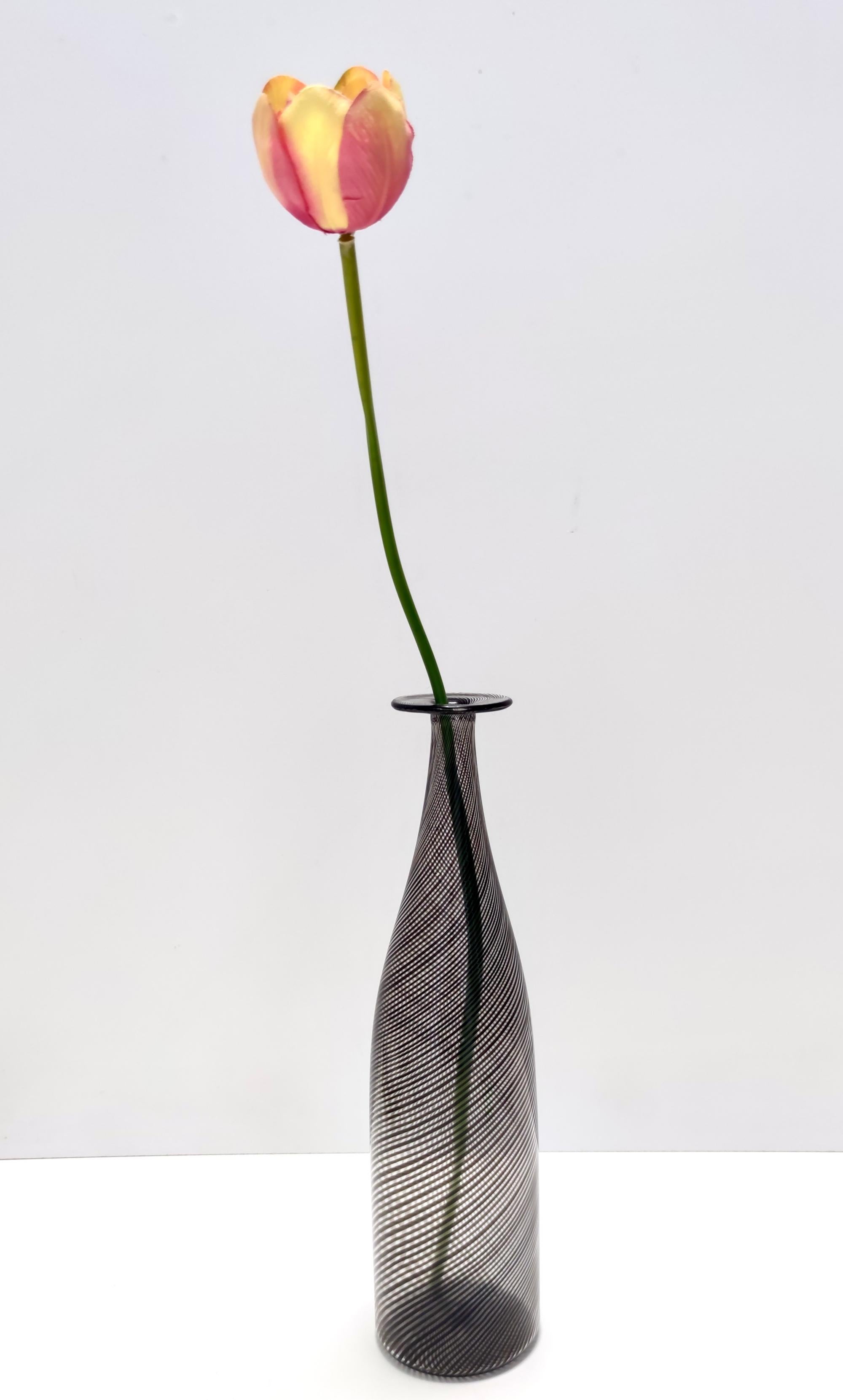 Hergestellt in Italien, 1950er - 1960er Jahre. 
Diese wunderschöne Vase / Flasche ist aus schwarzem und transparentem mezza filigrana Murano mundgeblasenem Glas hergestellt.
Da es sich um ein Vintage-Stück handelt, kann es leichte Gebrauchsspuren