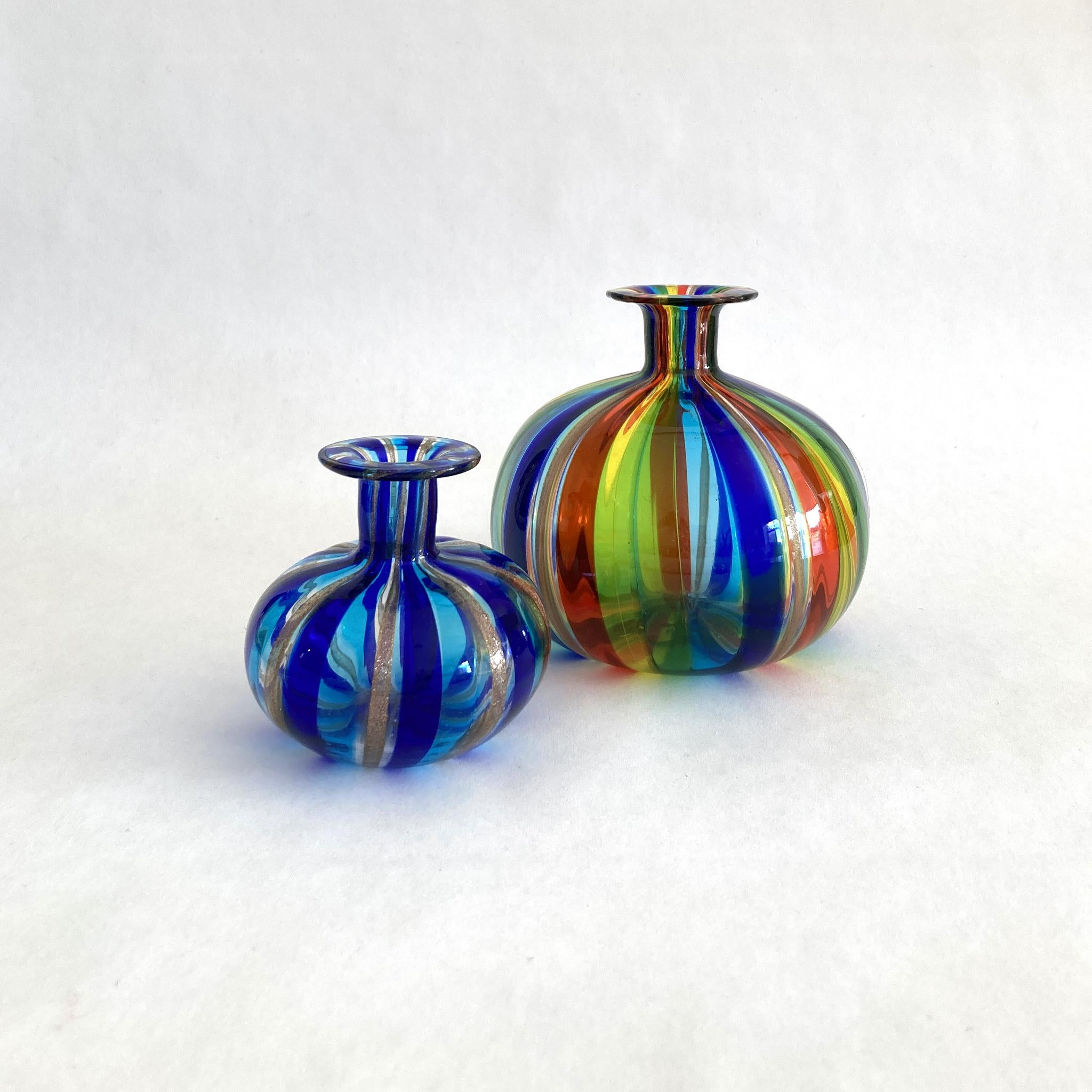 Stunning pair of hand blown Murano petite bud vases/ bottles in multicolor stripes including gold, blue, aqua, red, yellow and green. In great condition, no marks or cracks. Absolutely glittering in the light, see photos.

Multicolor larger vase:
