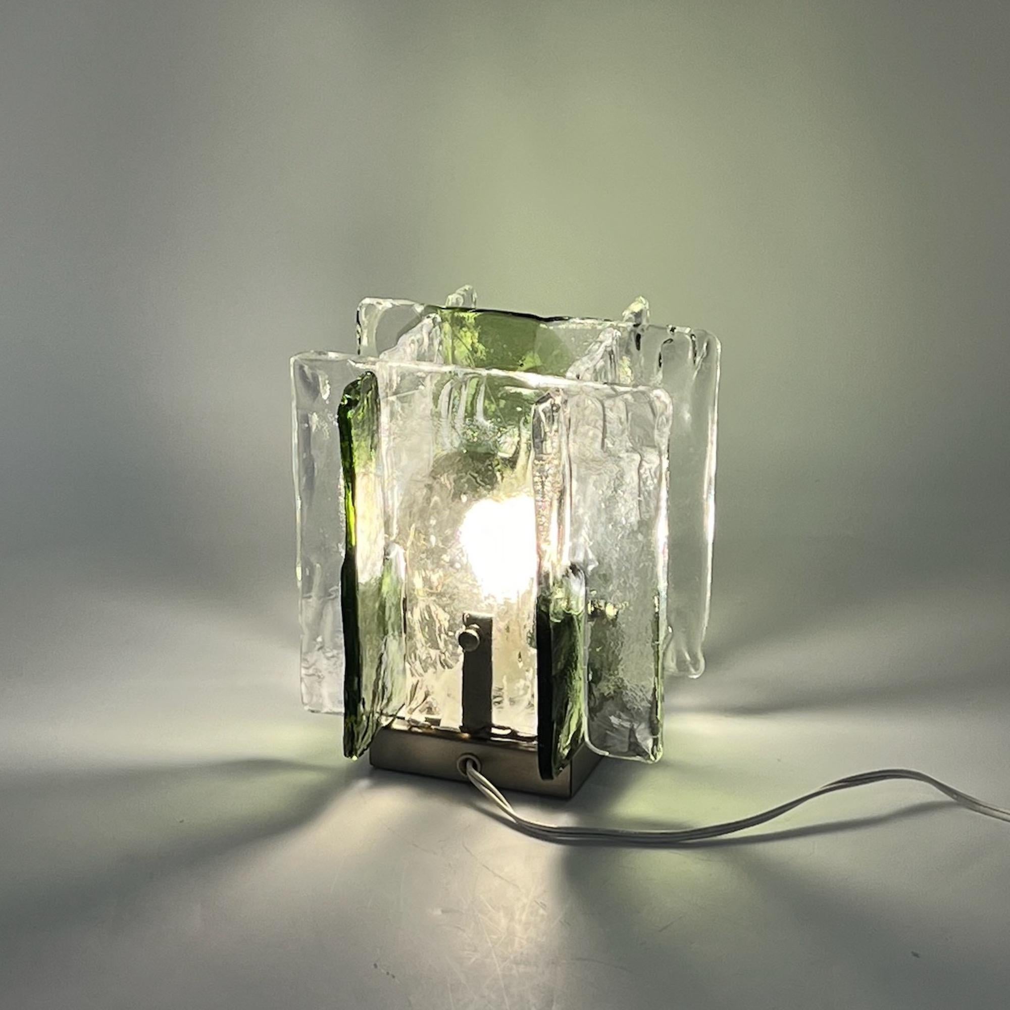 Superb vintage table lamp made of ice frost Murano glass with green and brown hues, crafted by the legendary Vetrerie Mazzega in Italy.

Made by four pieces of heavy and thick ice-like Murano glass, this iconic lamp exudes a vintage allure of