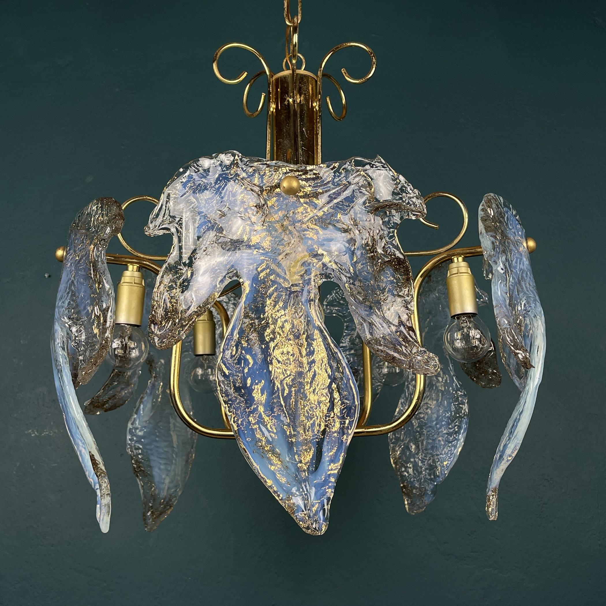 The absolutely fantastic vintage Murano glass chandelier made in Italy in the 1970s.
Consists of glass plates of Murano glass, made by Italian glassblowers. They follow the oldest Murano glassmaking technologies that were invented on the island of