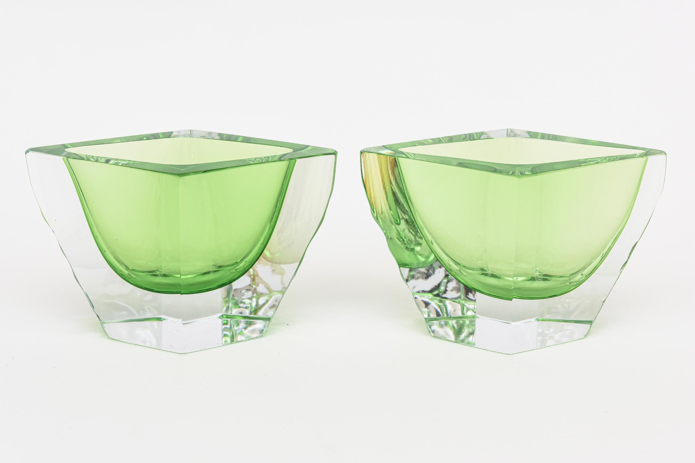 This pair of stunning jewel toned vintage Murano bowls are the most spectacular color of kelly green meets a lighter green with clear. They are by Alessandro Mandruzzato and are very unusual in their form. They are angled and have a flat cut