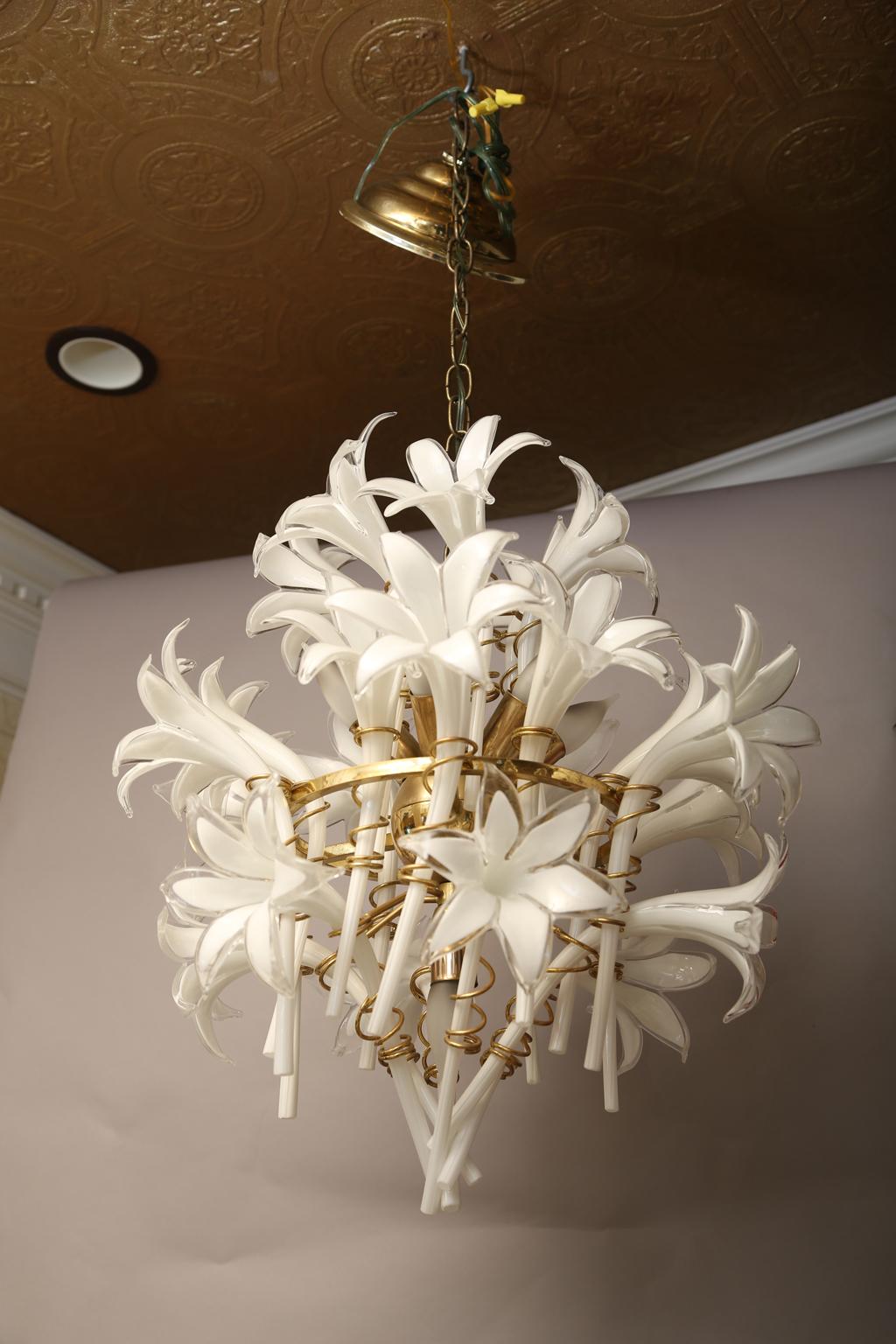 Floral chandelier, of Murano glass, having a frame of brass, it's spherical center holding twenty-four, handblown, blooms in the form of lilies. 

Stock ID: D1793.