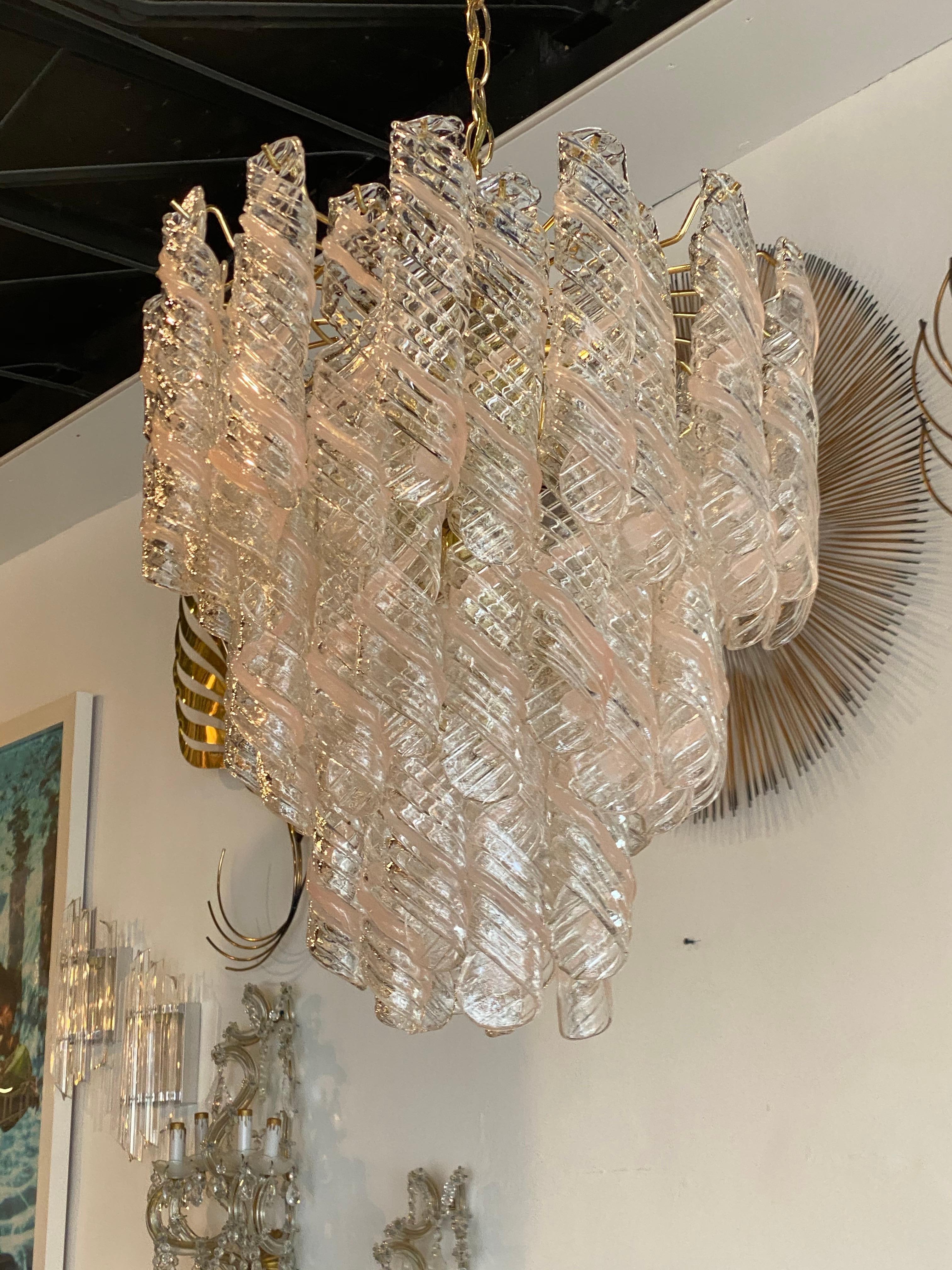 Lovely vintage Murano Mazzega Torciglione pink and clear glass swirl chandelier, 3 tiers, 8 lights. No chips or breaks to any of the glass pieces. Comes with brass ceiling CAP. Also listing matching 2-tier chandelier.