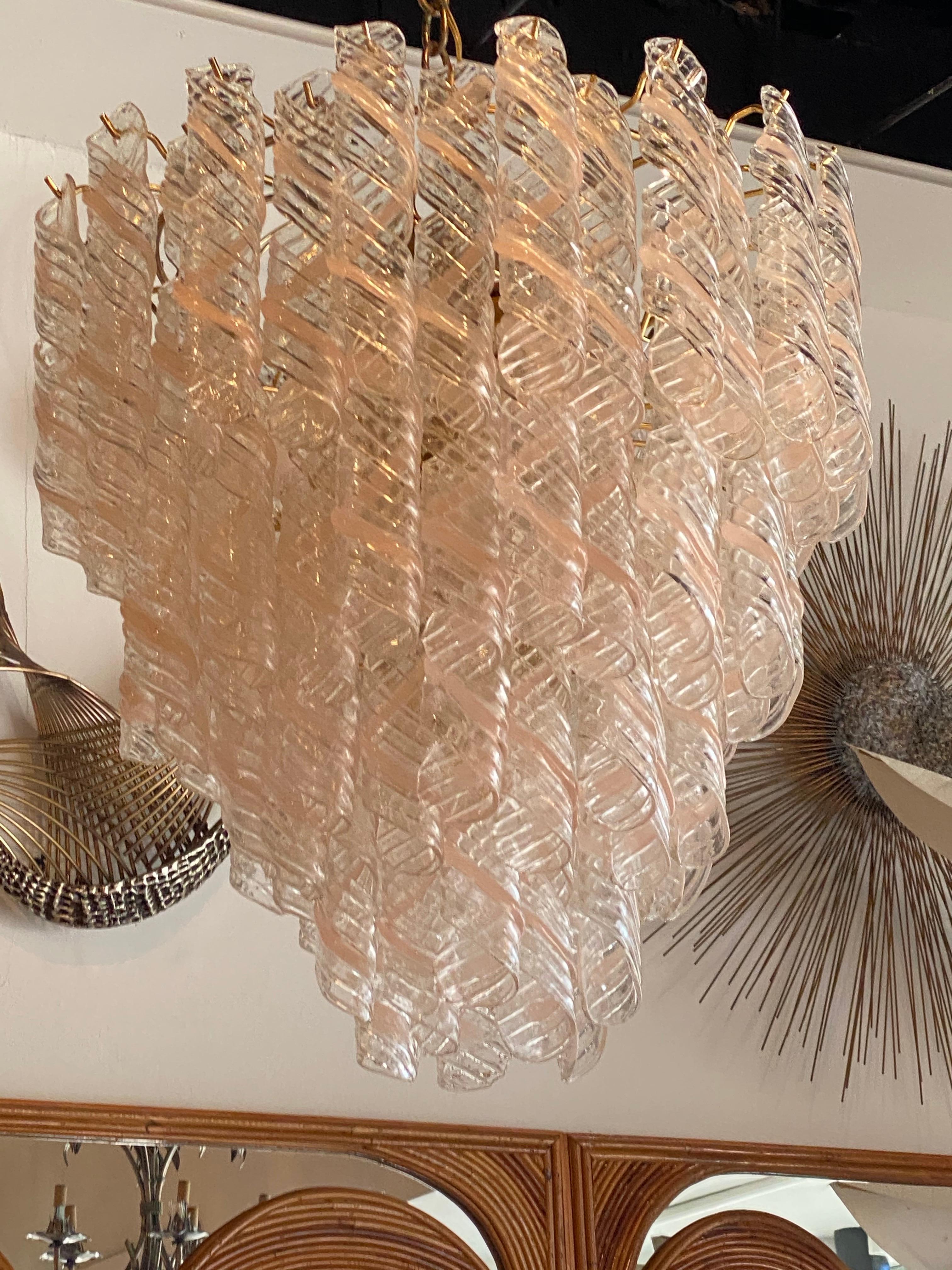 Lovely large vintage Murano Mazzega Torciglione pink and clear glass swirl chandelier, 4 tiers, 13 lights. No chips or breaks to any of the glass pieces. Comes with brass ceiling CAP.