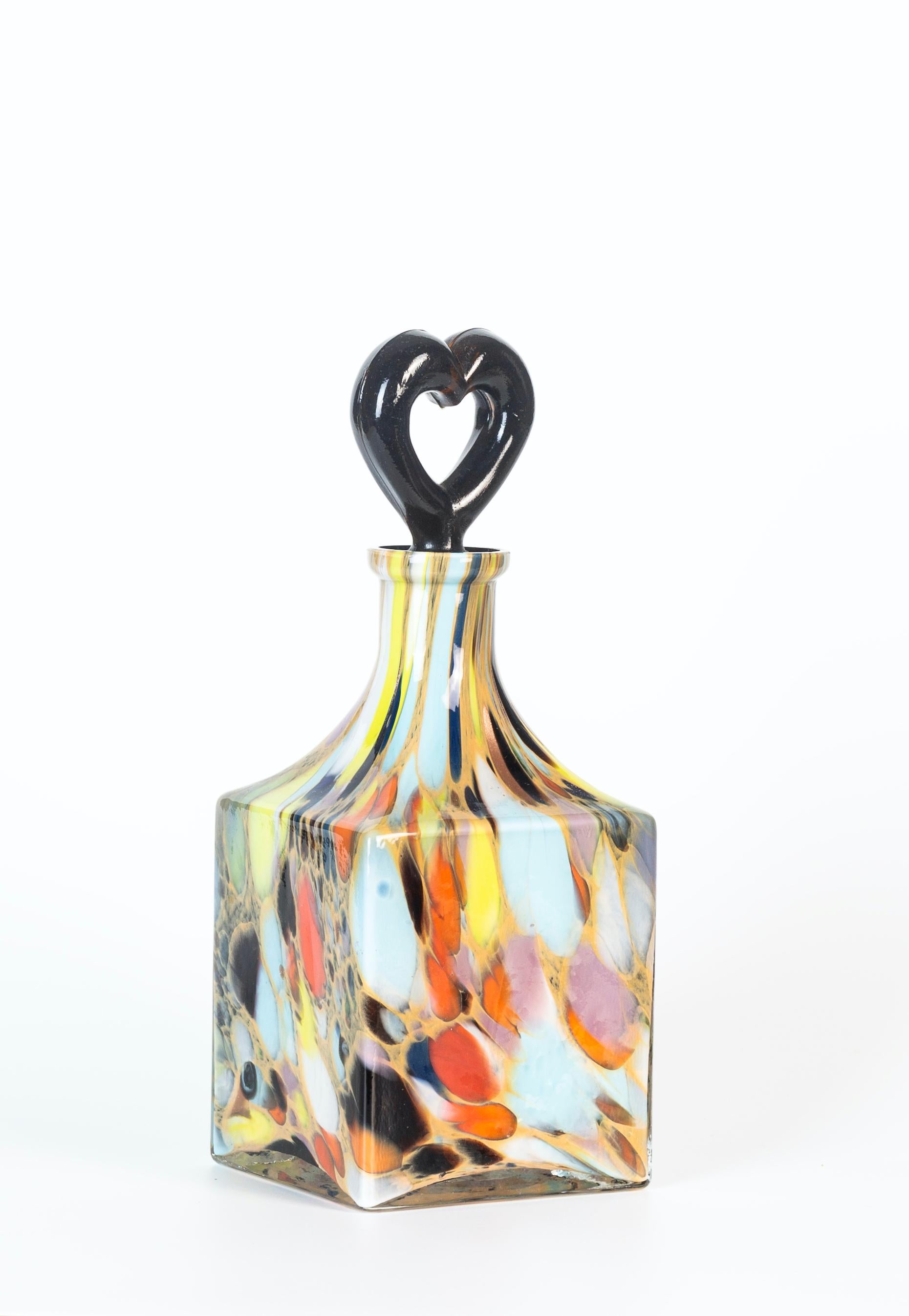 Murano colored bottle is a wonderful glass decorative object, realized during the 1970s.

Very beautiful mixed colored Murano bottle with heart shaped stopper.

Very good condition.