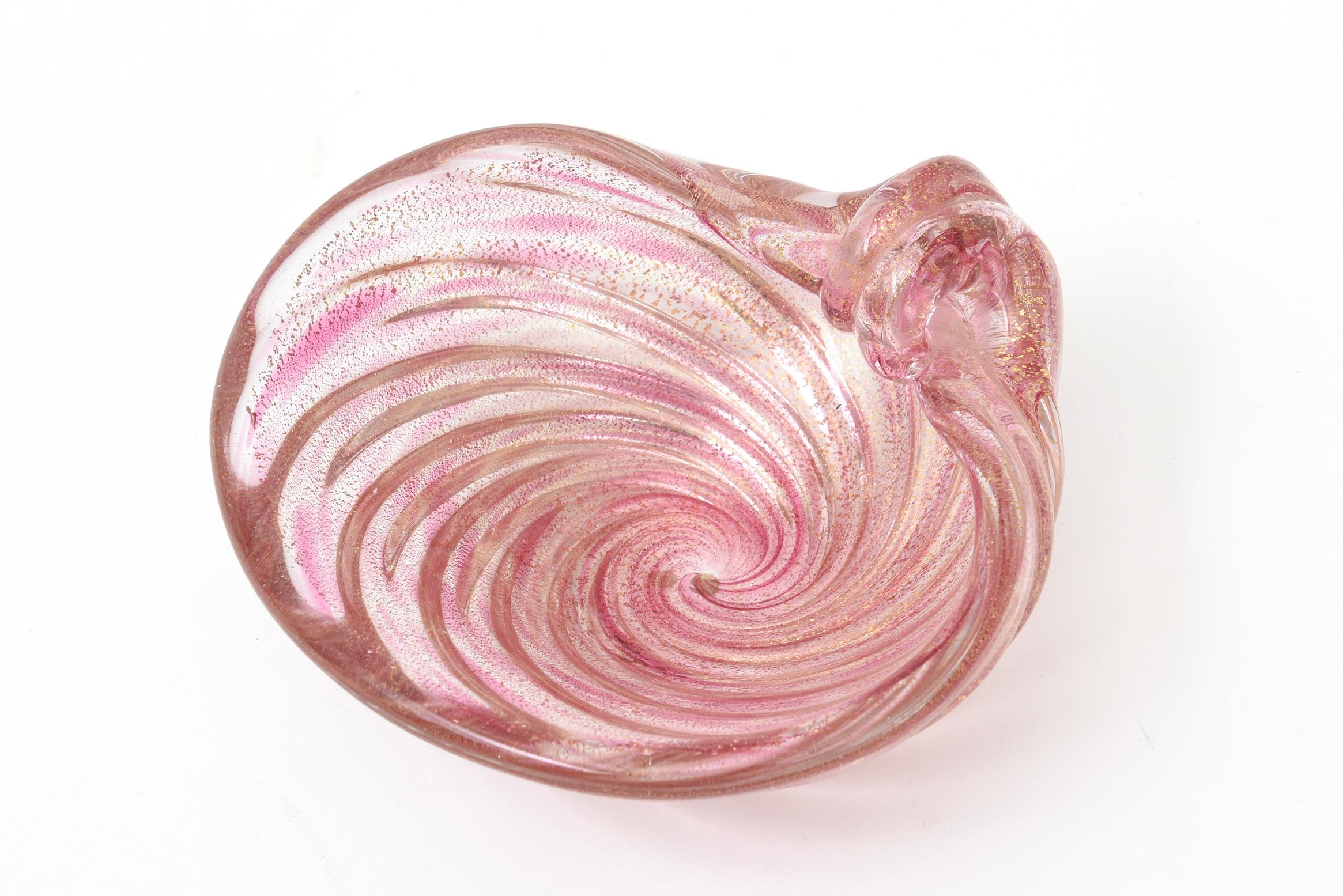 This beautiful small gem of a vintage Murano Archimede Seguso small glass bowl is in the shape of a coiled snail with abundant gold aventurine. The hot pink and light pink swirls offset the gold with richness. Could be used for serving or as a