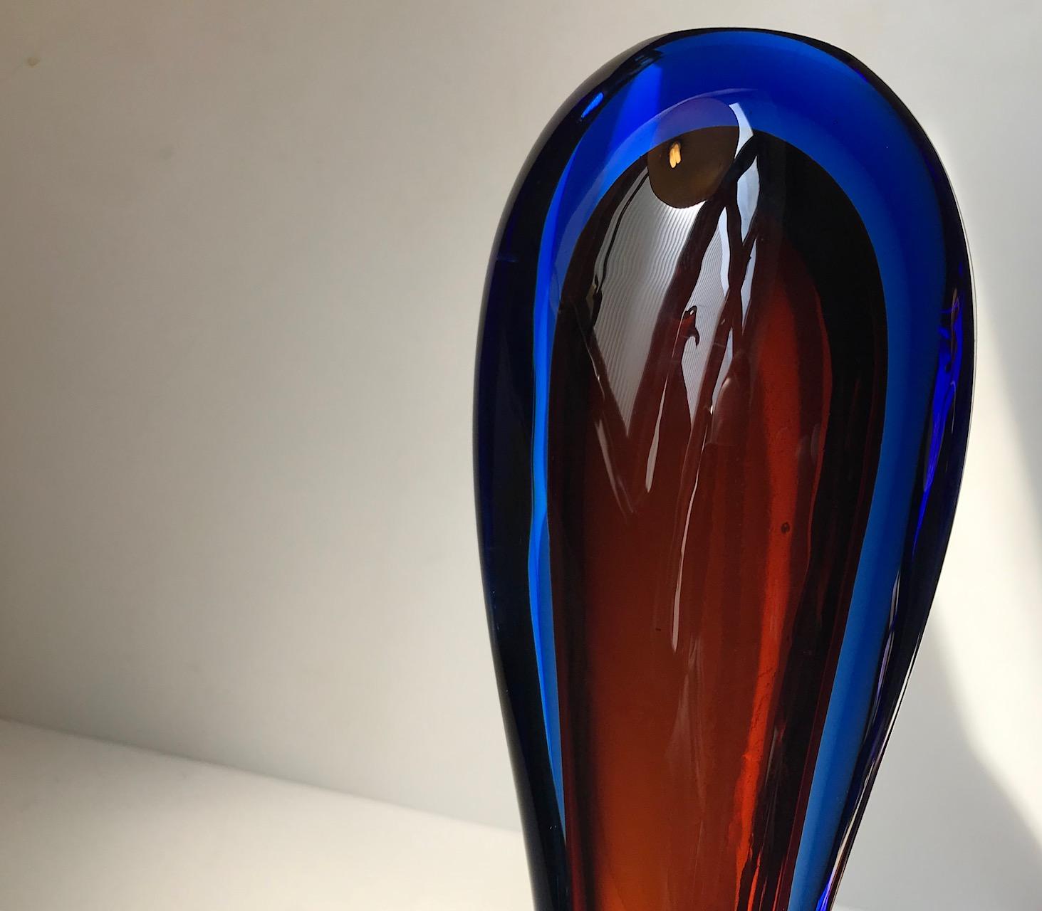 Heavy and thick decorative longneck vase composed of cobalt blue and deep red Sommerso glass. Designed by Flavio Poli and manufactured at Seguso in Murano Italy during the 1960s.