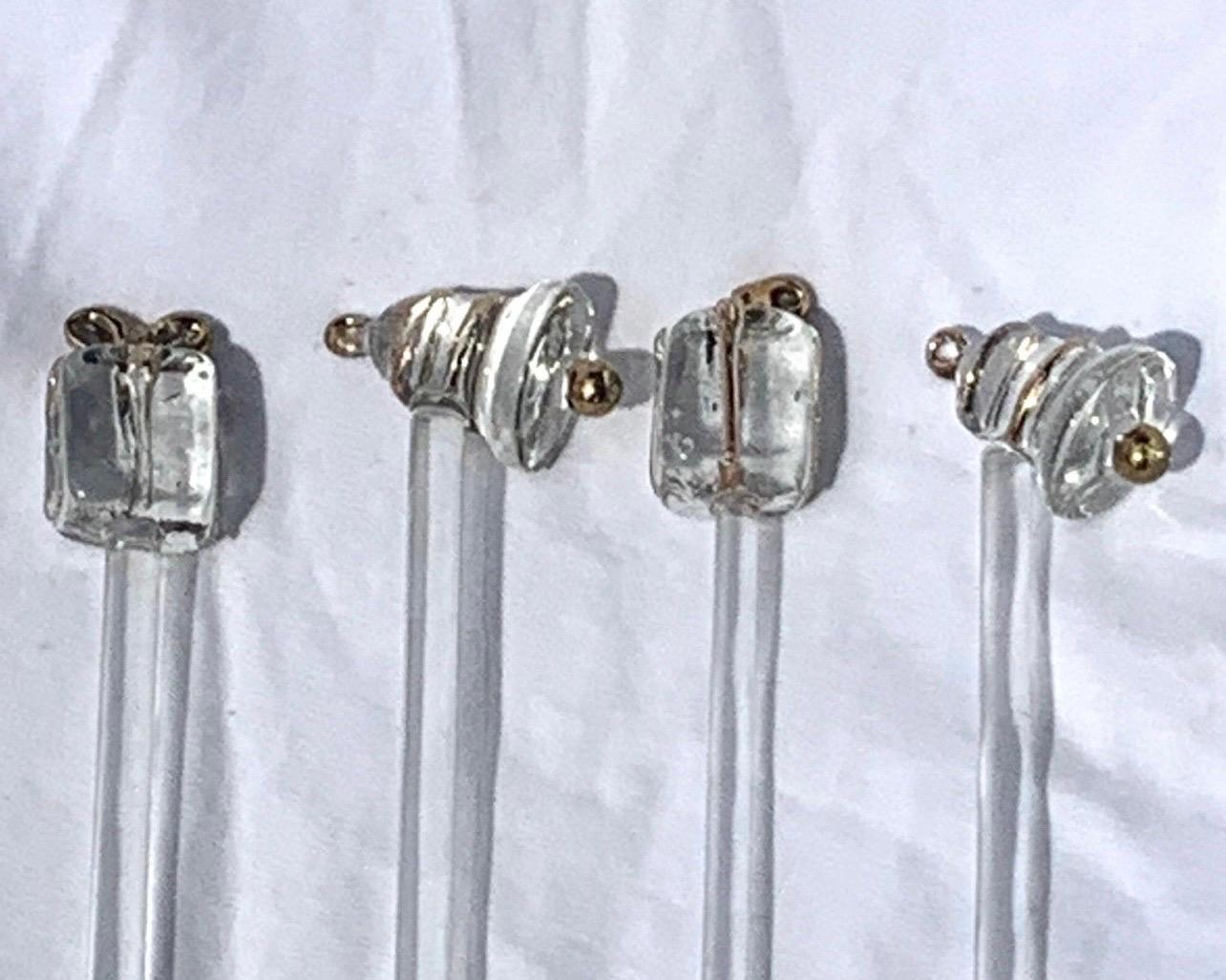 A set of 4 clear art glass swizzle sticks.  2 with presents on the end and 2 with bells.   No chips or cracks.  Fantastic for your holiday bar!  