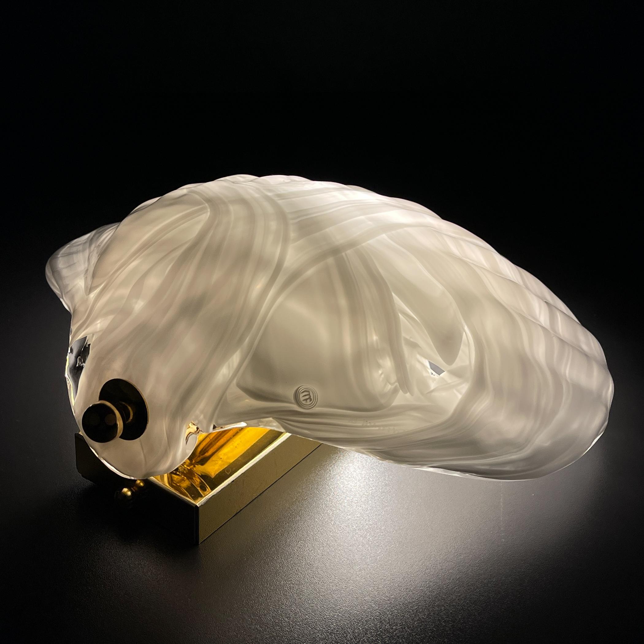 Original murano wall lamp Seashell by La Murrina made in Italy in the 1980s.
La Murrina is a symbol of excellence in design with unique glass products “Made in Murano”. Thanks to its strong roots and high artisan skills, the company operates in the