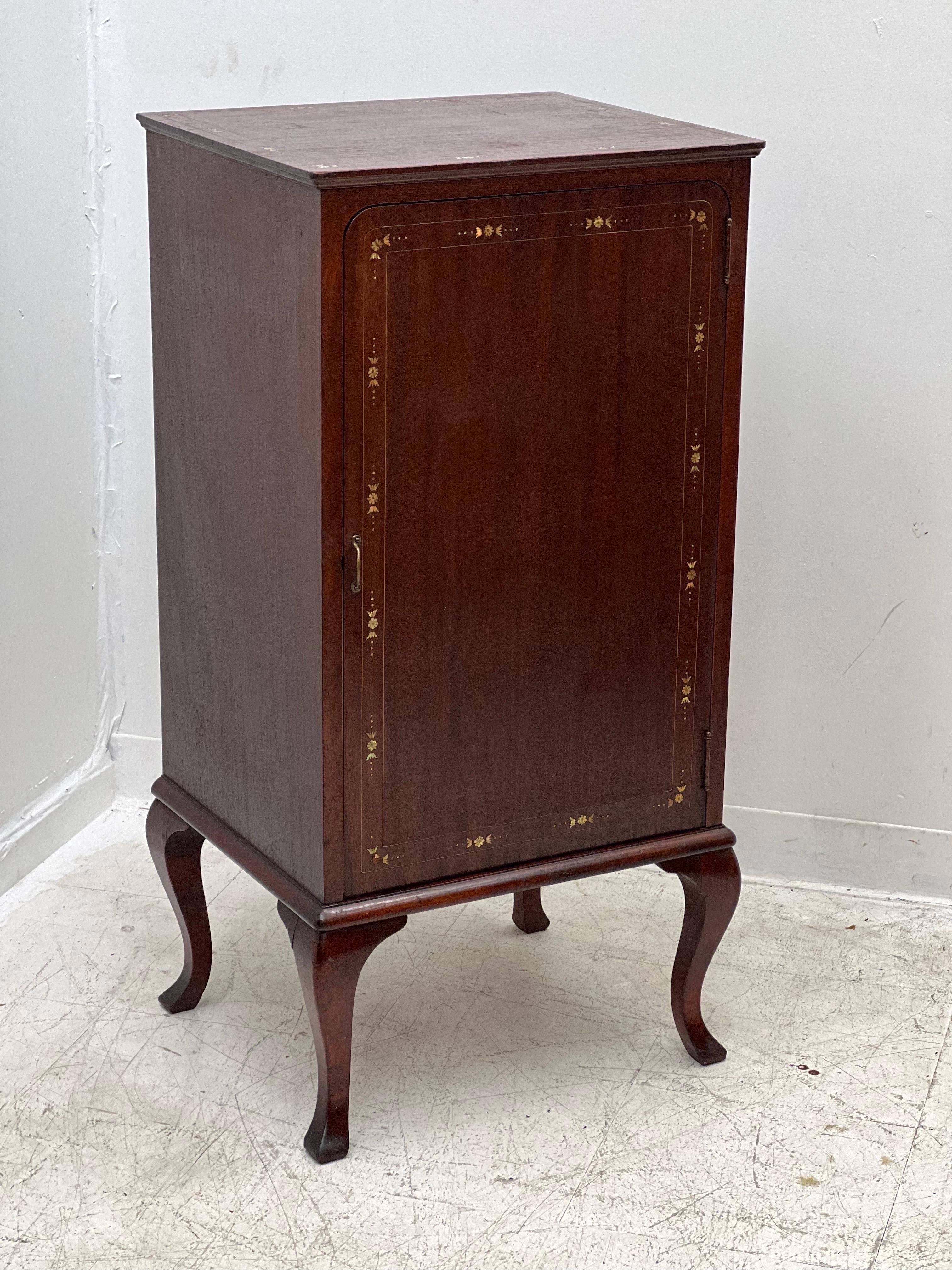 Vintage music cabinet with decorative inlay.

Dimensions. 20 W; 17 D; 40 H.