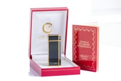 Accendino vintage Must de Cartier in lacca nera e placca d'oro