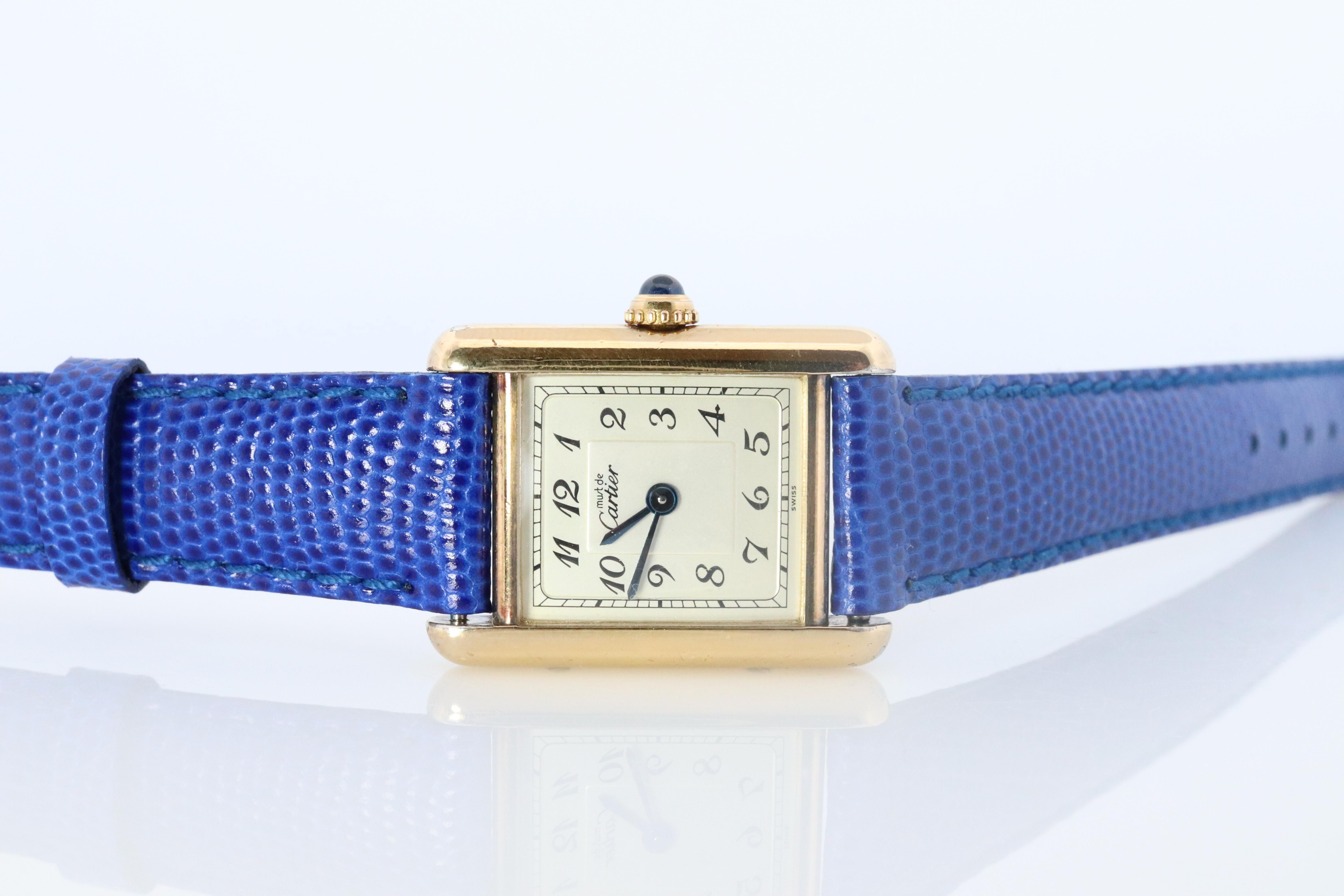 Genuine Cartier watch. Vintage Iconic Tank Argent. Sterling Silver and 18k Gold plated (Vermeil).

Ref 5057001

RARE Arabic Numbers Dial.

New Gucci Leather Band.

Condition: New Battery installed.

Details:
21mm by 28mm Case
White Dial with Arabic