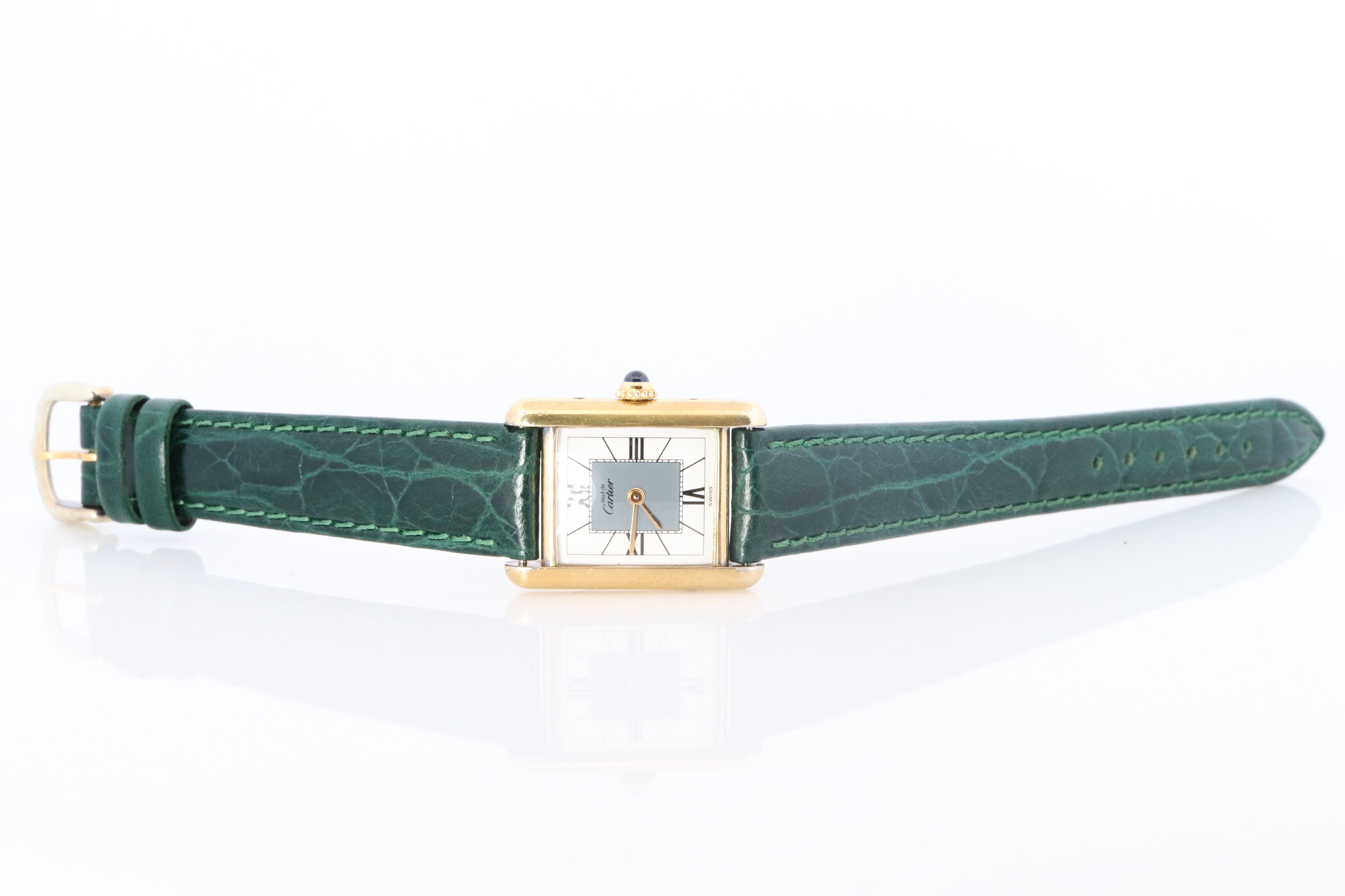 Genuine Cartier watch. Vintage Iconic Tank Argent. Sterling Silver and 18k Gold plated (Vermeil).

Ref 5057001

RARE Gray and White Dial

New Leather Band.

Condition: New Battery installed.

Details:
21mm by 28mm Case
Quartz Battery