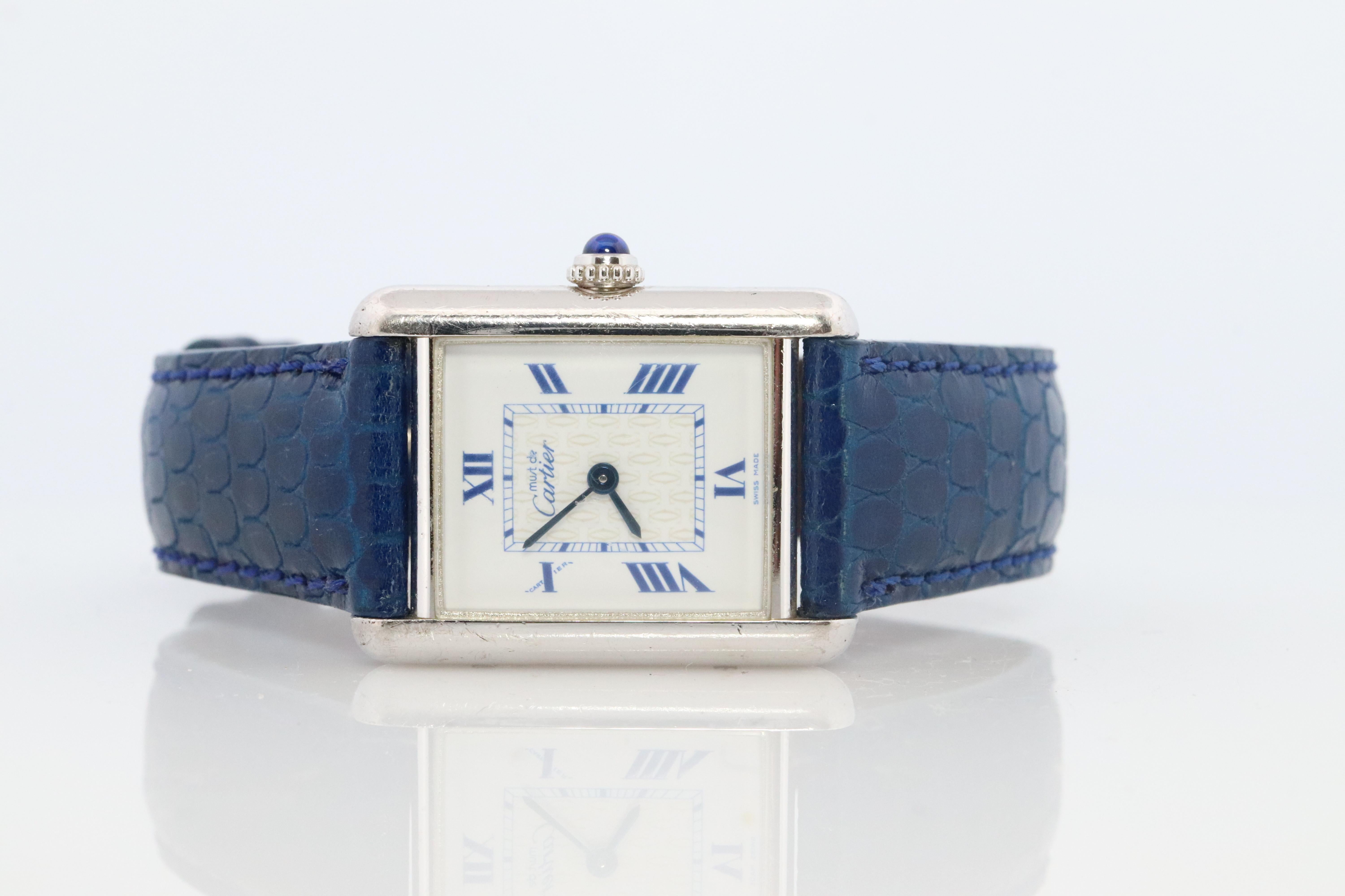 Genuine Cartier watch. Vintage Iconic Tank Argent. Sterling Silver

Comes with a new leather band 

Rare White Dial and Blue Roman Numerals

Ref 2416

Condition: New Battery installed. Review Photos

Details:
22.5mm by 30mm by 7mm Case
Rare Blue