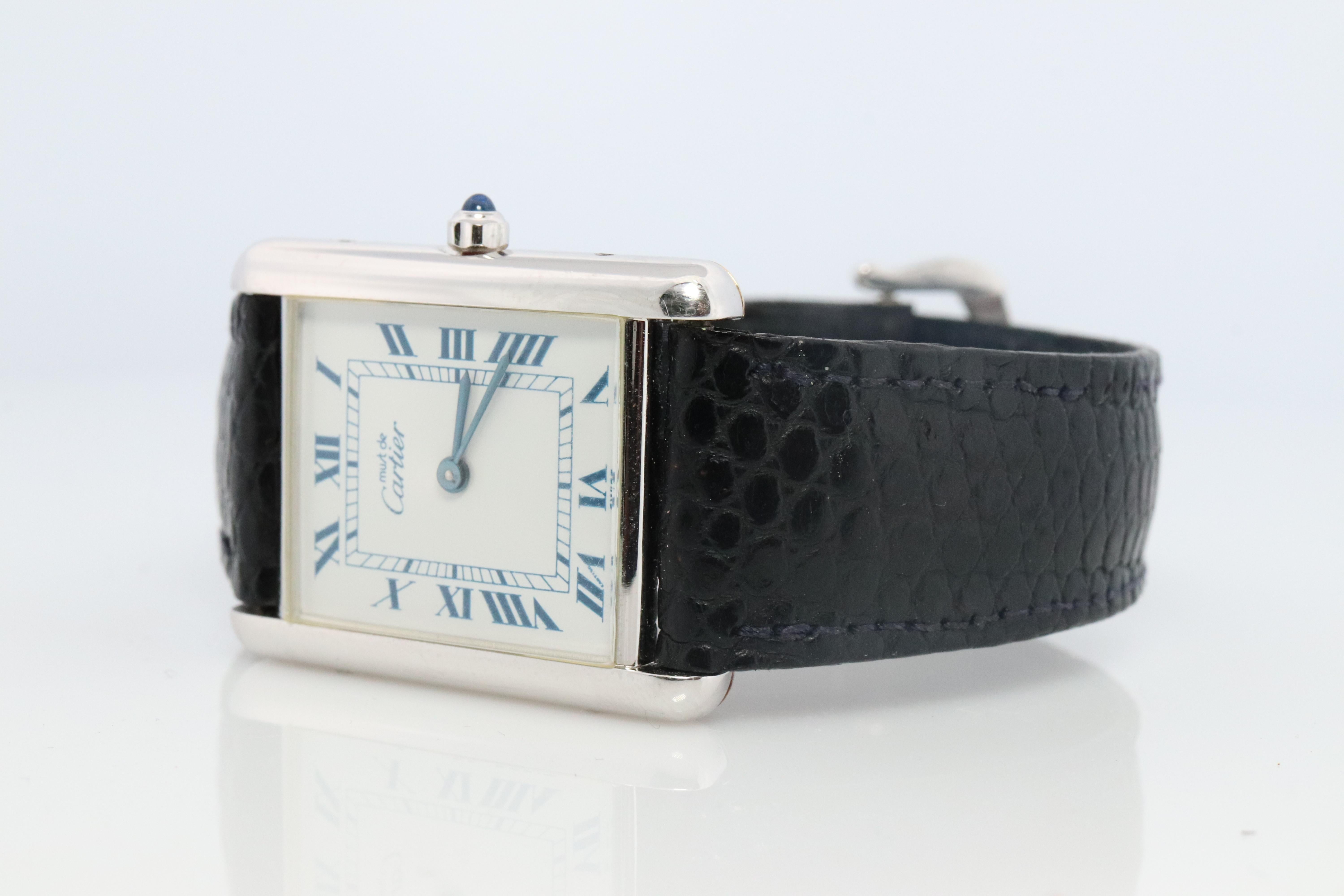 Genuine Cartier watch. Vintage Iconic Tank Argent. Sterling Silver and Gold plated (Vermeil).

Comes with original Cartier leather band and Original Cartier clasp.

Rare White Dial with Blue Roman Numerals.

Condition: Just Serviced. New Battery